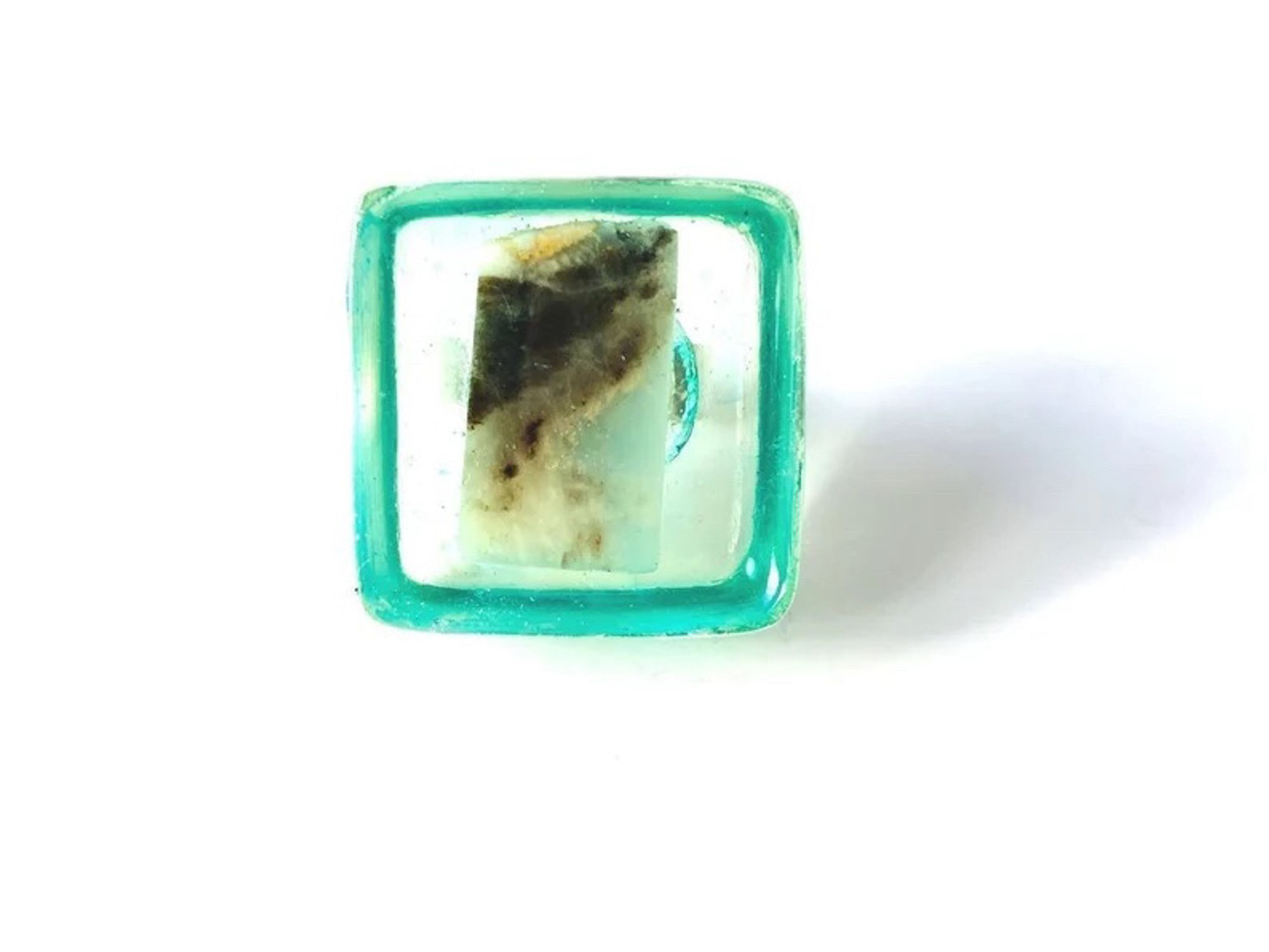 Ring with square cube of clear aqua resin with multicolored piece of natural stone in it