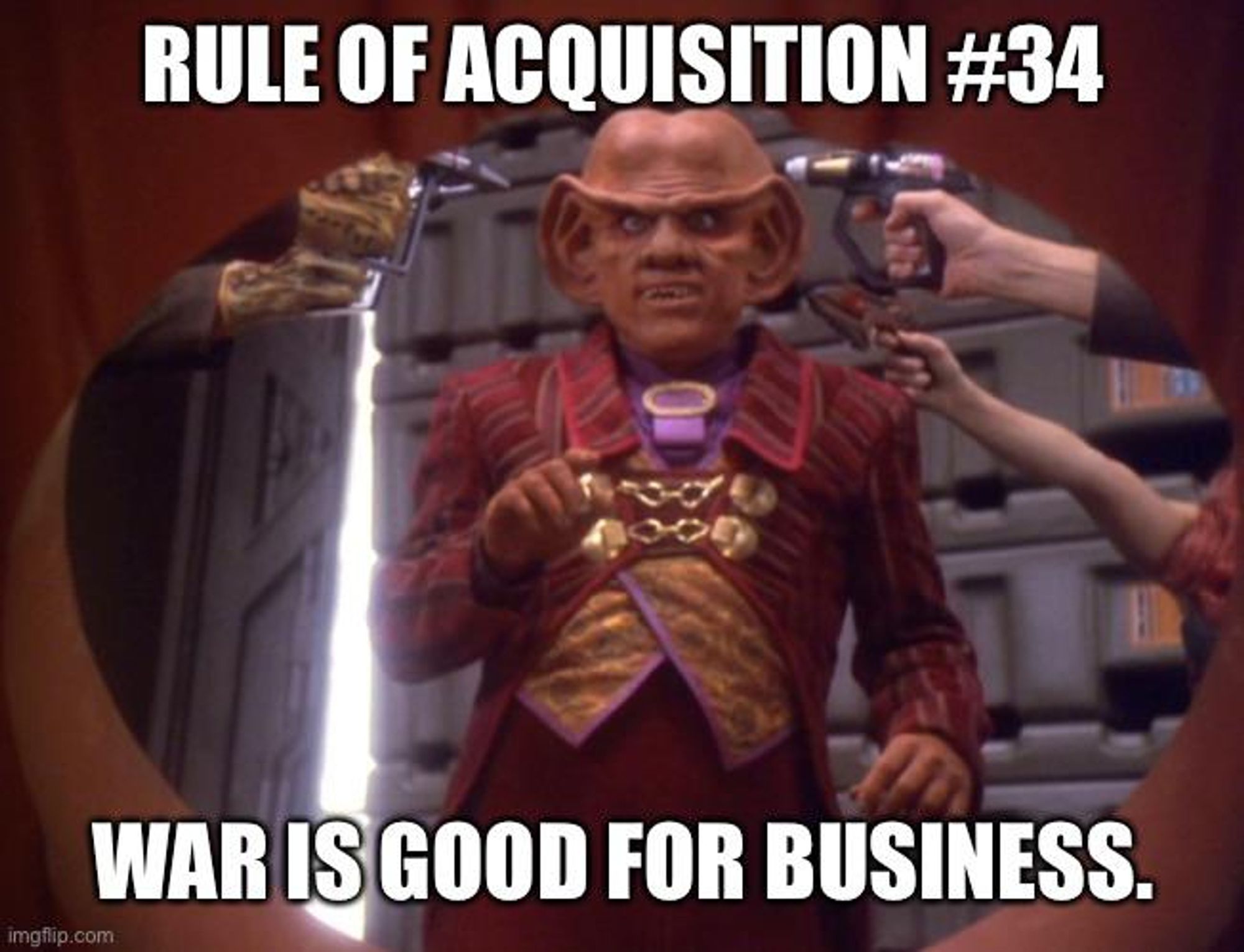 Picture of a Ferengi male with phasers pointed at his head. Captioned with "Rule of Acquisition #34: War is good for business."