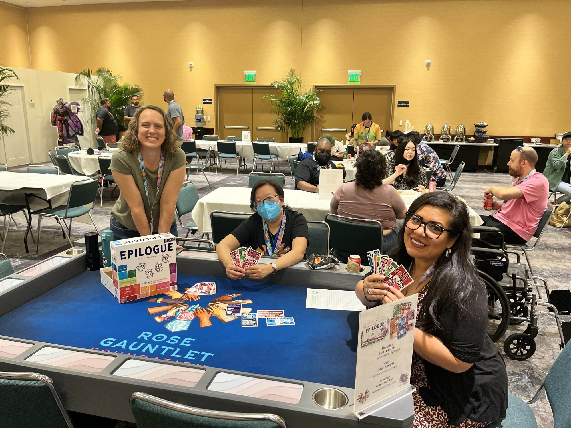 Elizabeth Hargrave, Amanda Panda, and Ell Firespray playing Epilogue in the BIPOC lounge at Gen Con 2024.