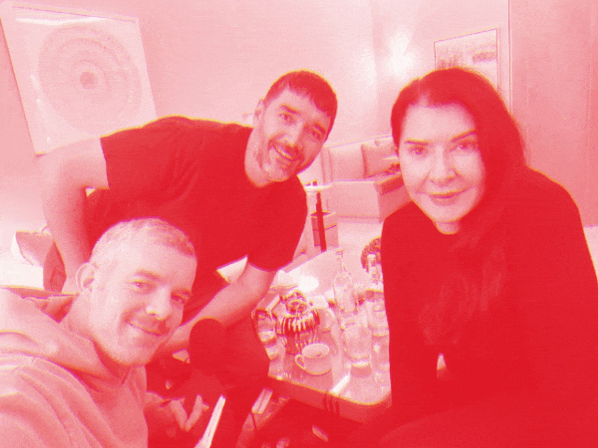 Picture in duotone red/white with Marina Abramović, Russell Tovey & Robert Diament