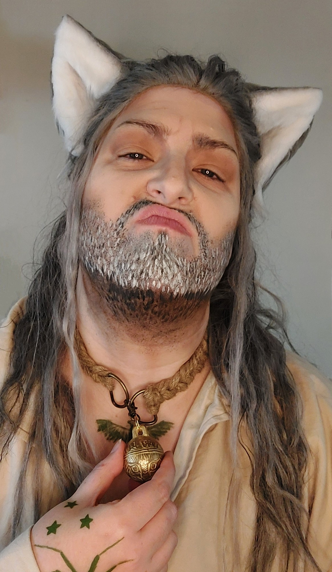 Portrait photo of Blackbeard cosplayer in a simple pirate shirt wearing a cat collar and cat ears