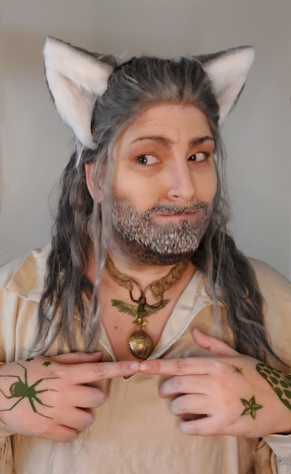 Portrait photo of Blackbeard cosplayer in a simple pirate shirt wearing a cat collar and cat ears