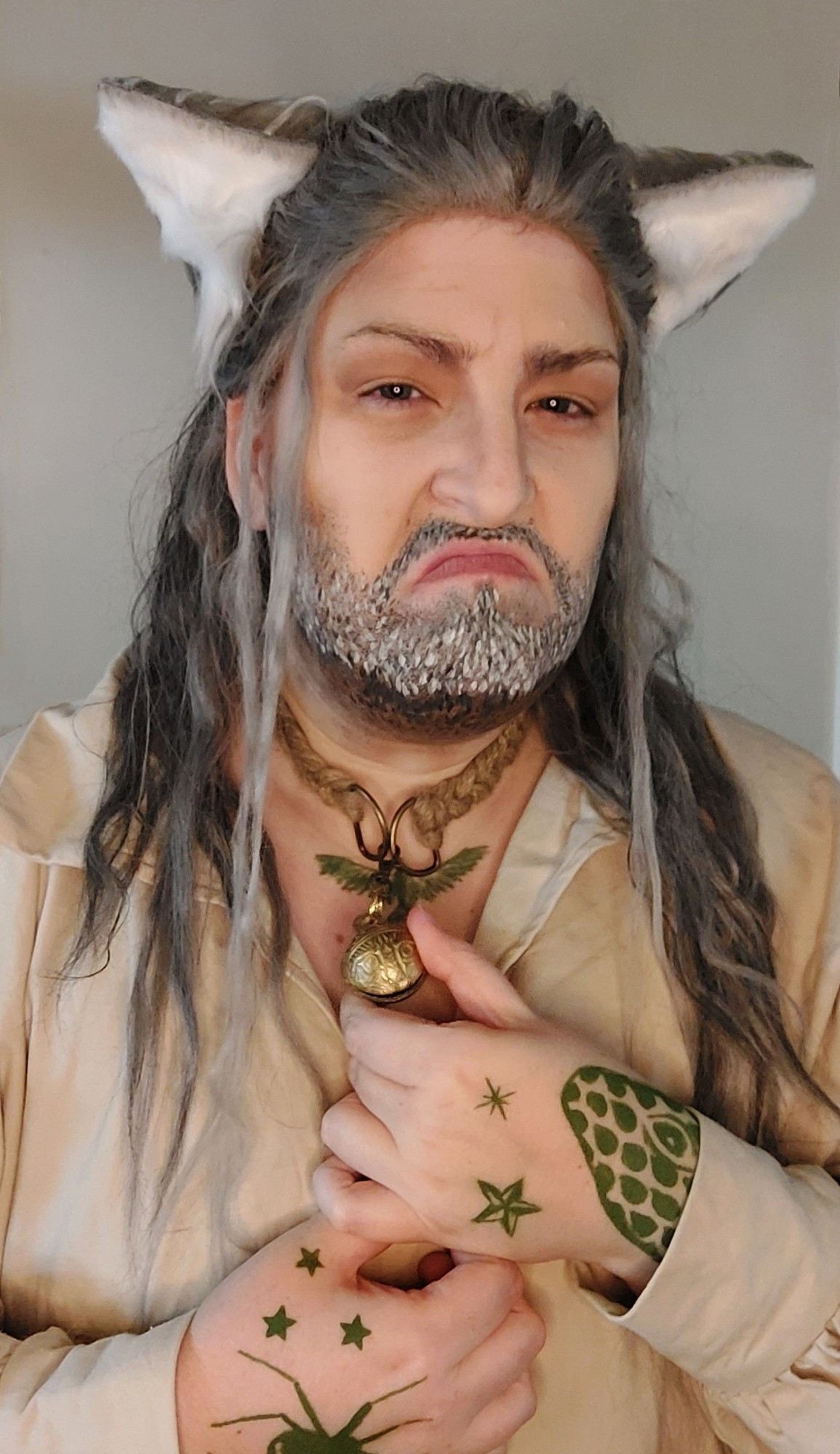 Portrait photo of Blackbeard cosplayer in a simple pirate shirt wearing a cat collar and cat ears