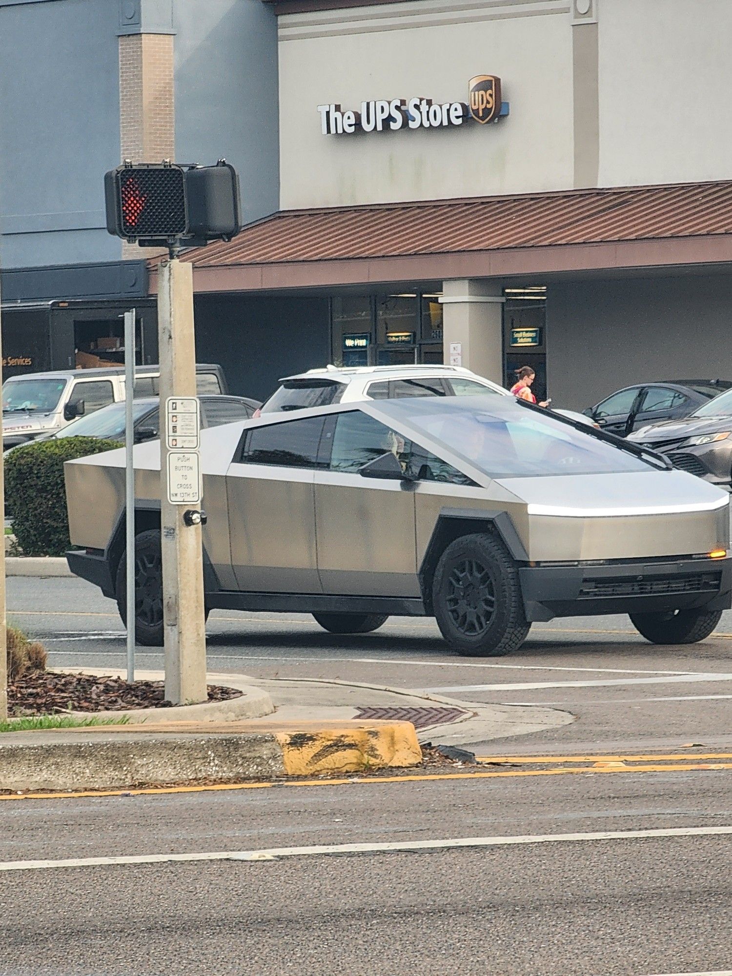 A Cybertruck that looks like the cover of a knockoff Trapper Keeper the worst kid at your grade school trashed, with ugly dark streaks down all the metal panels