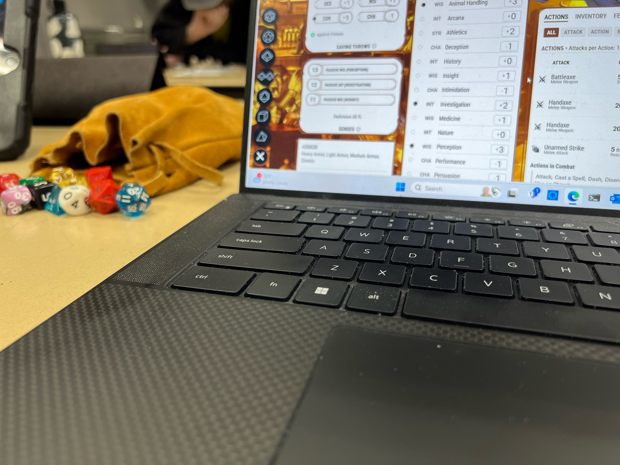 Bag of Dice and DnD Beyond on a laptop.