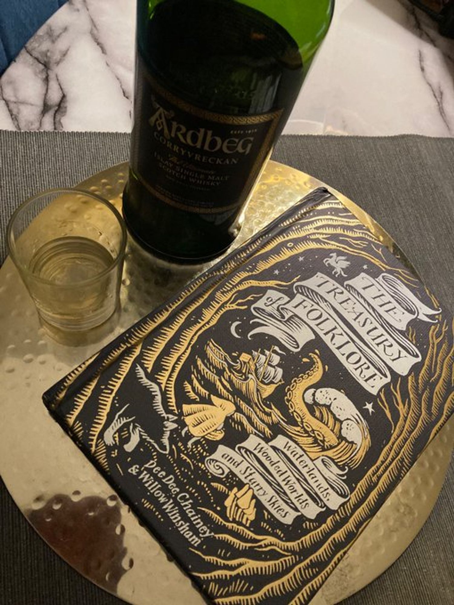 Ardbeg bottle with The Treasury of Folklore book.