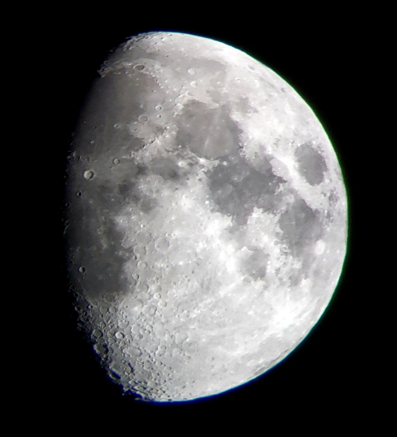 a picture of the moon at roughly 3/4 visibility taken through a telescope