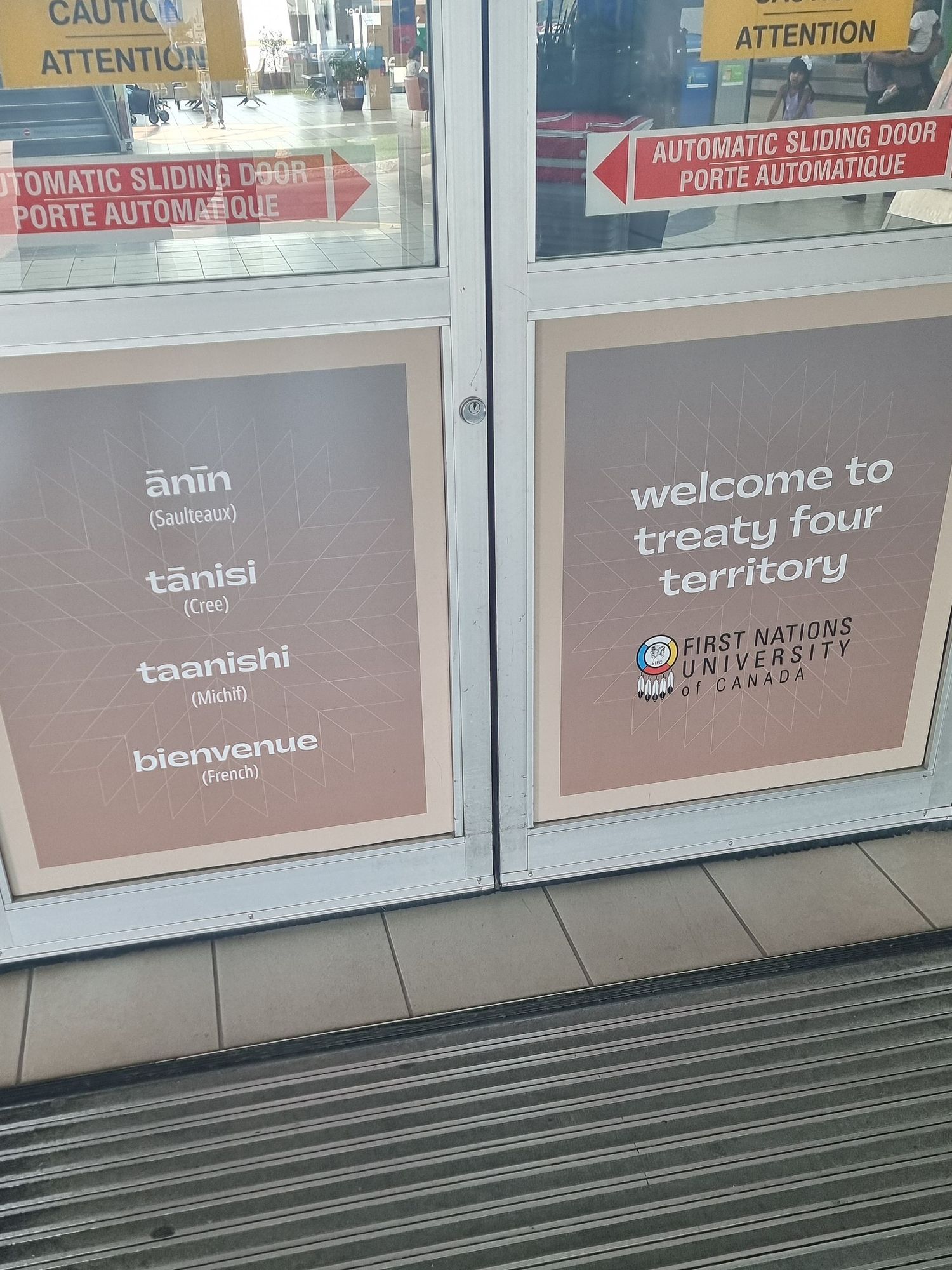 A sign at Regina Airport reading welcome to treaty four territory and welcome in Saulteaux, Cree, Michif, and French