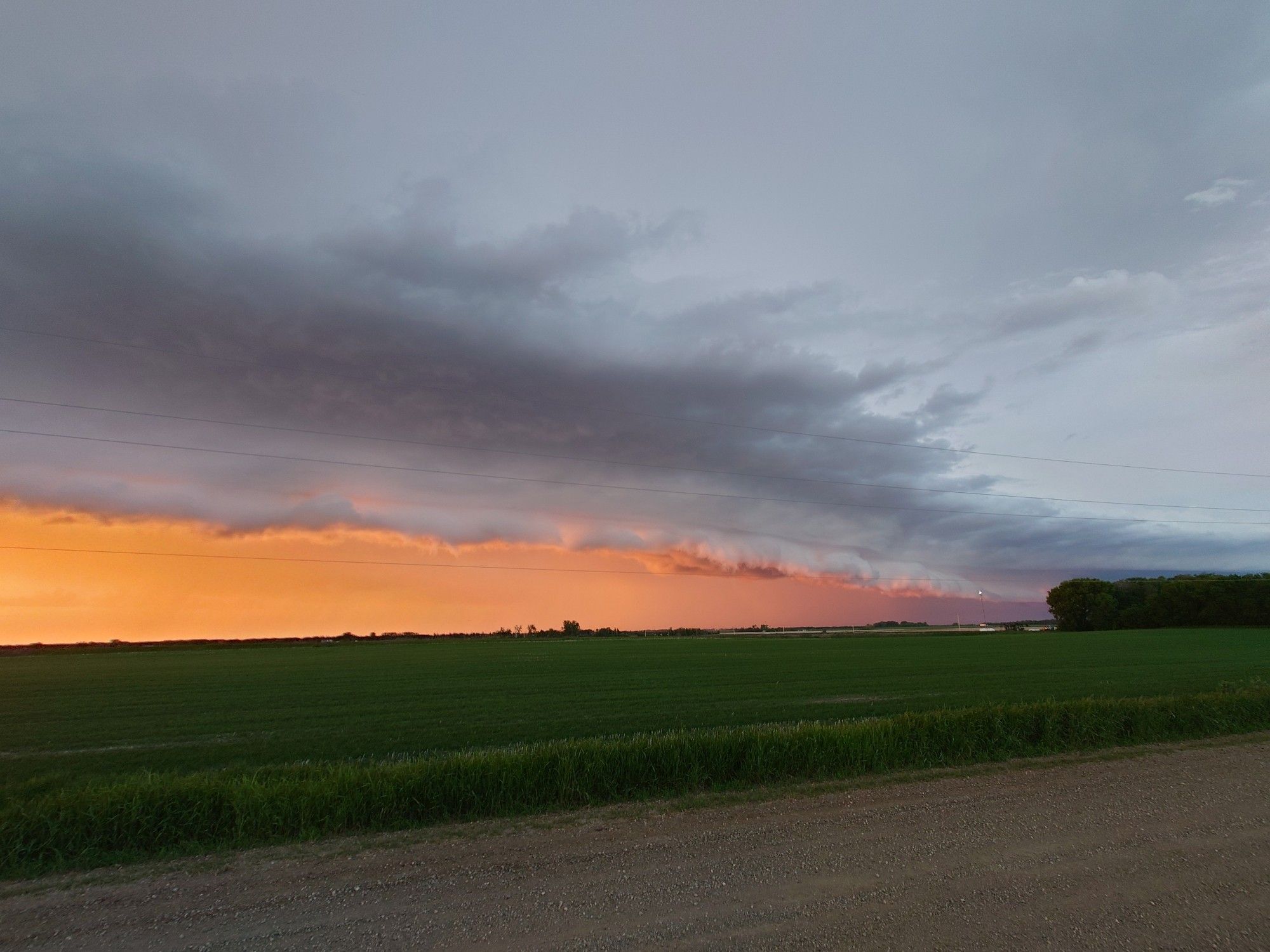 Shelf cloud with orange light.