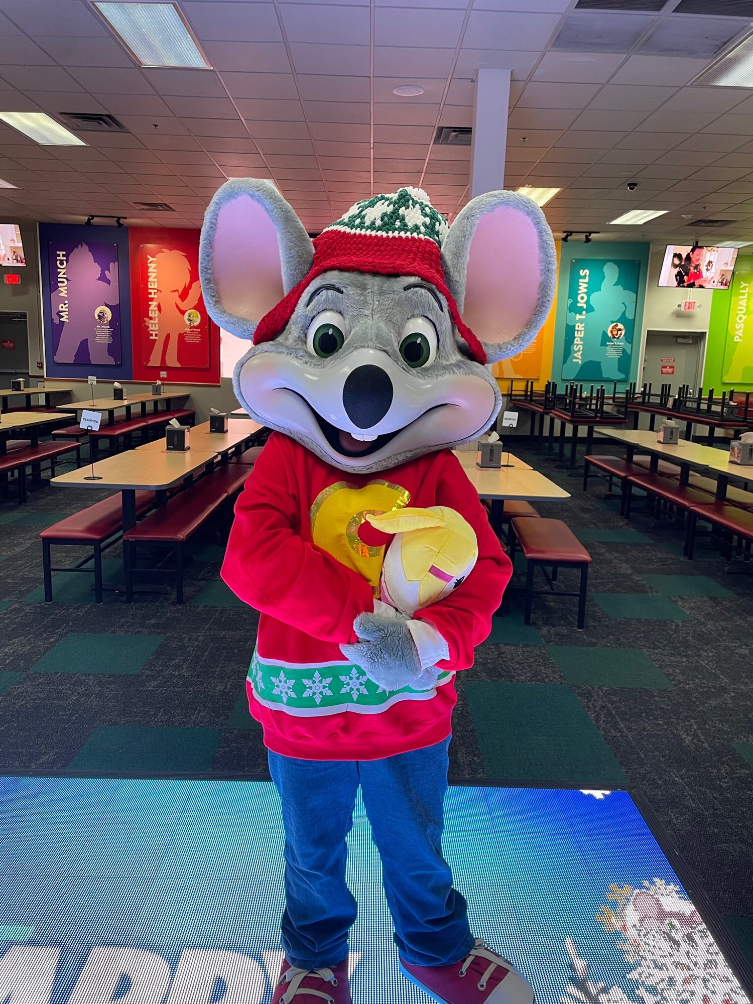 Chuck E. Cheese costume at Chuck E. Cheese the location wearing a fursuit beanie made by YarnRabbit