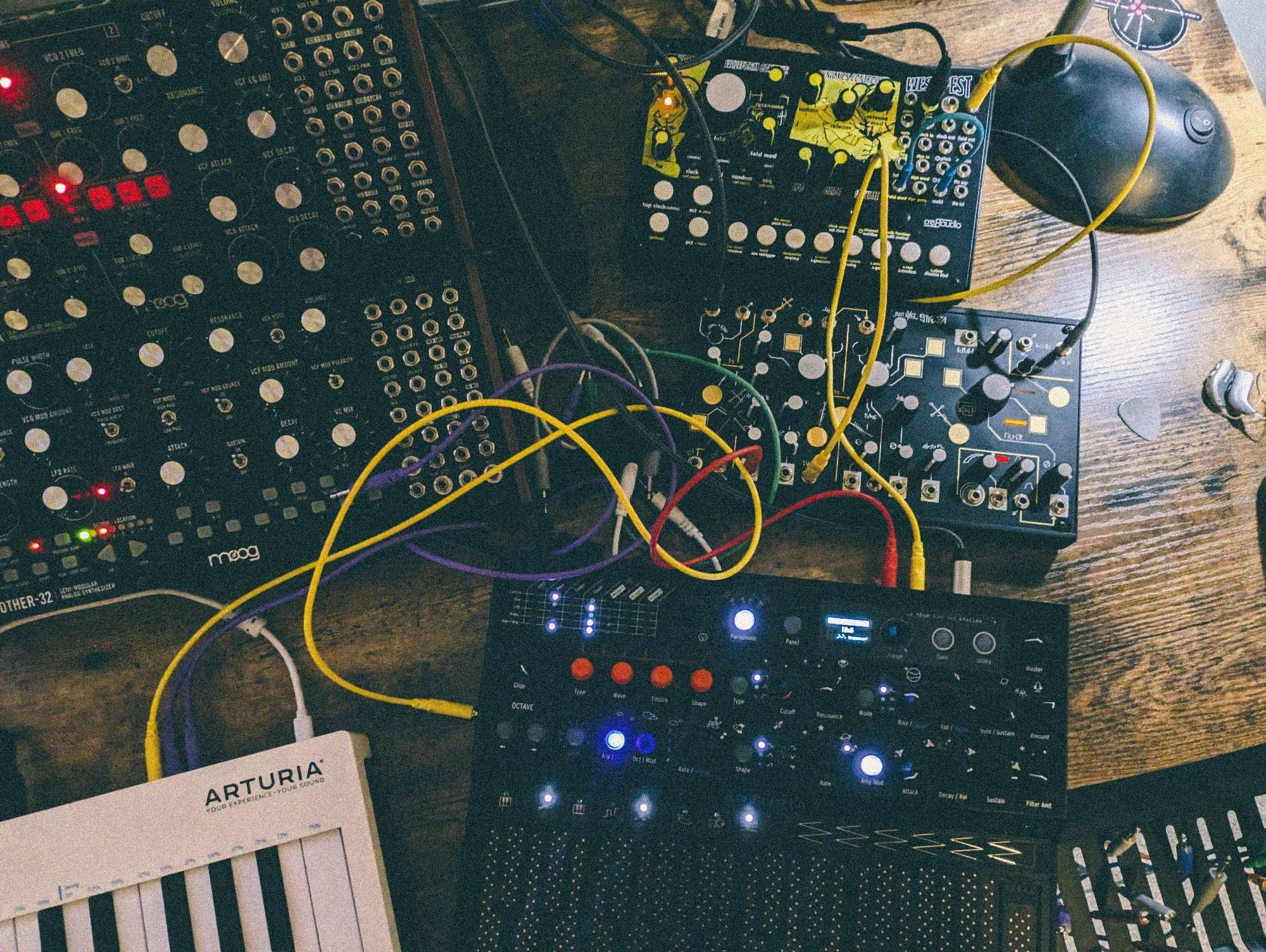 Synths. Arturia microfreak. Make noise strega, cre8 west pest Moog Mother 32 and Subharmonicon arturia keystep just out of frame patch cables running amok