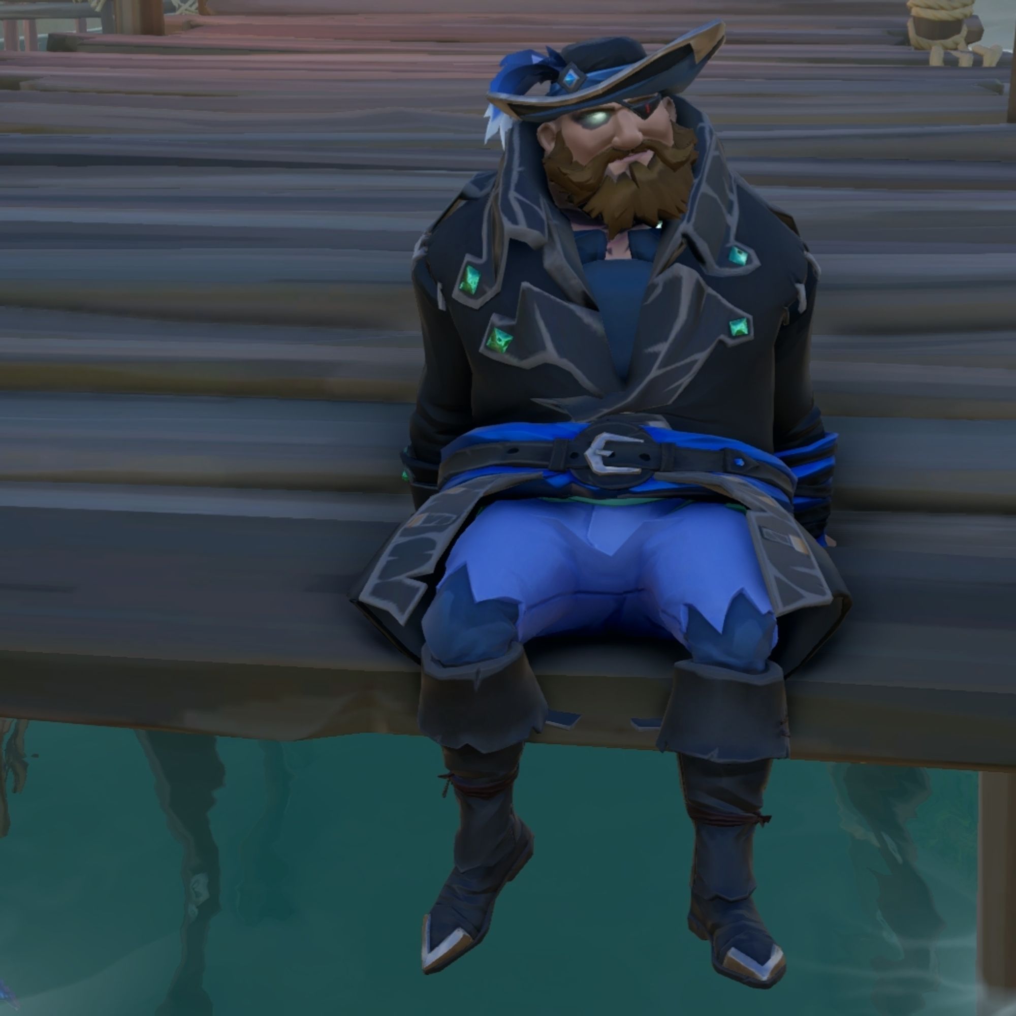 Pirate dressed in black and blue clothes sitting on the end of a dock.