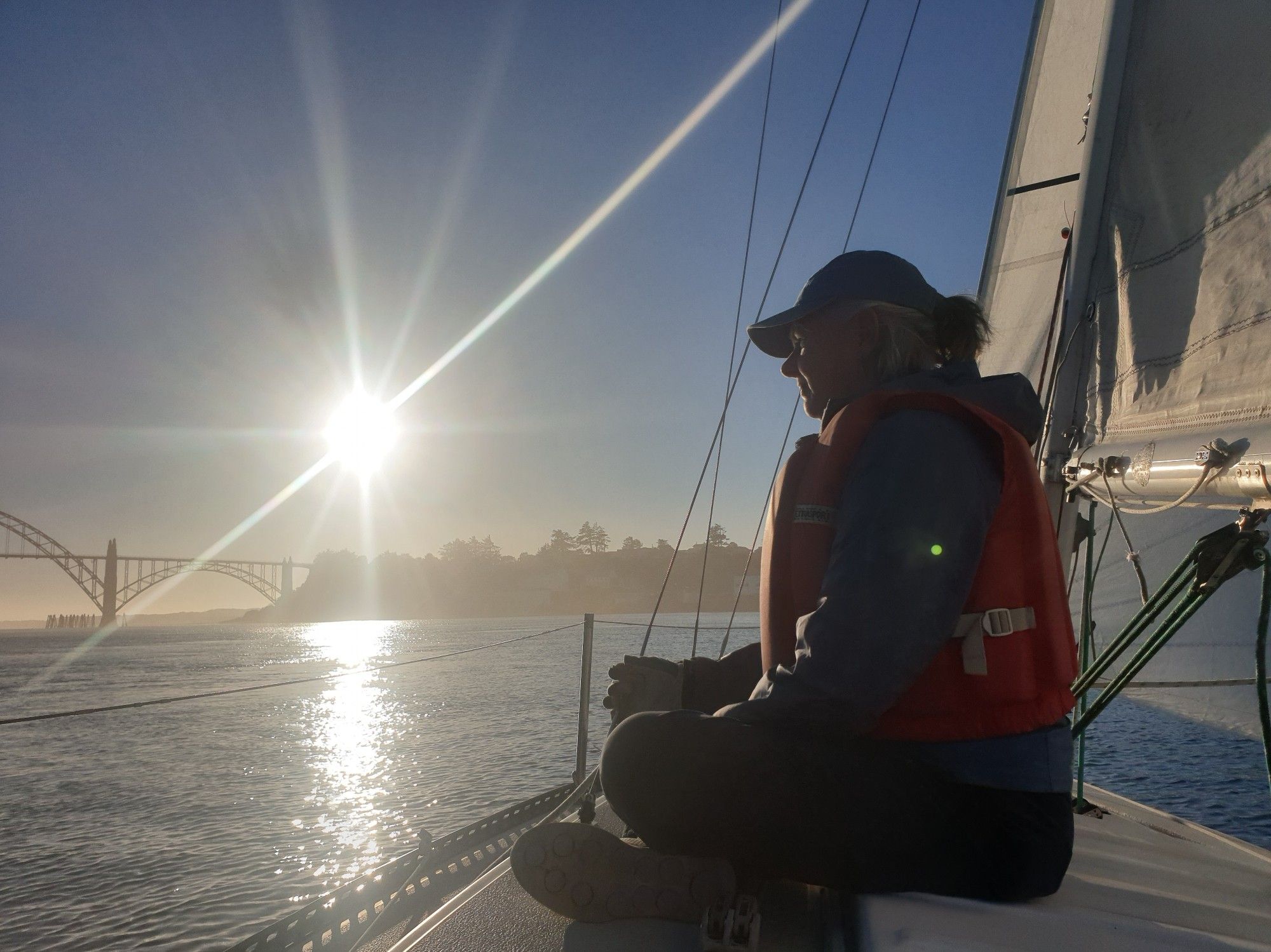 Sunset illuminates a sailor