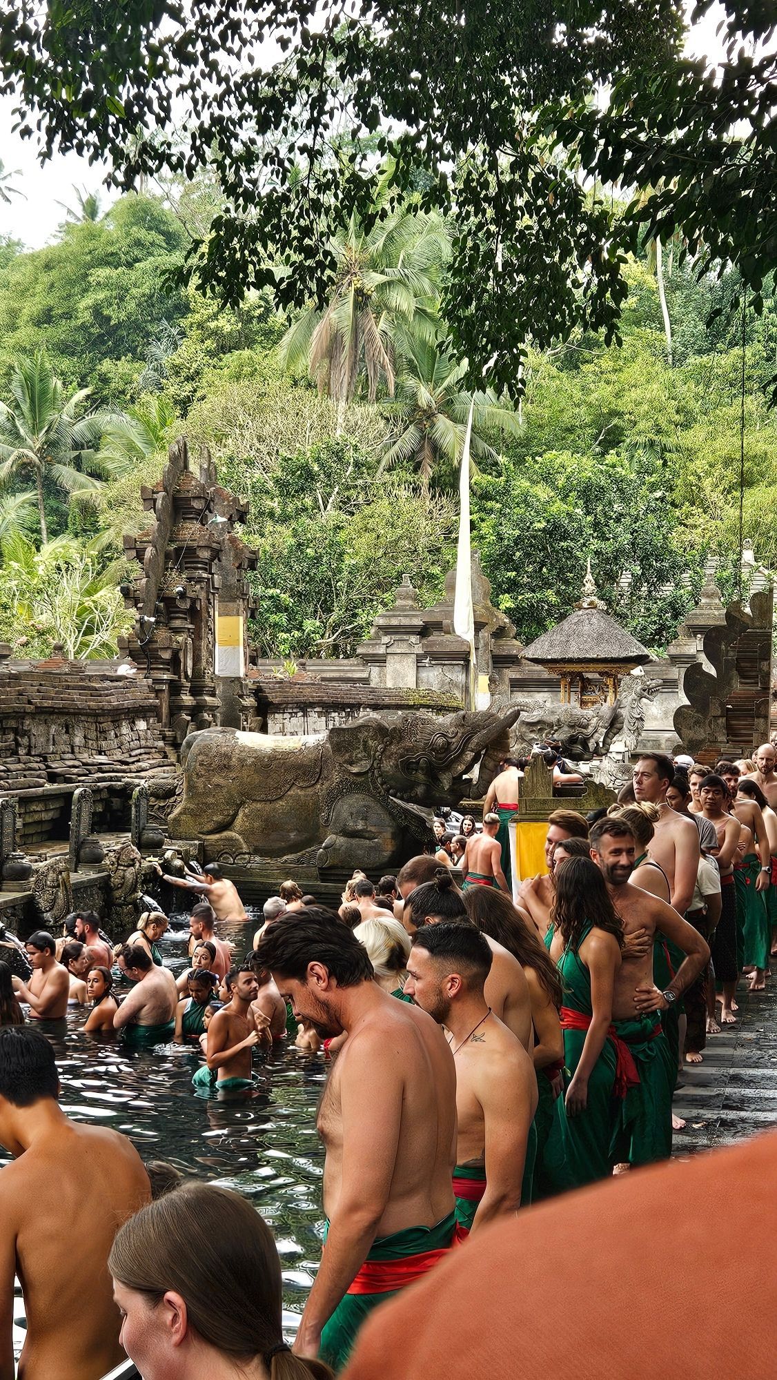 Viele Menschen drängen sich in heiligen Quellwasser