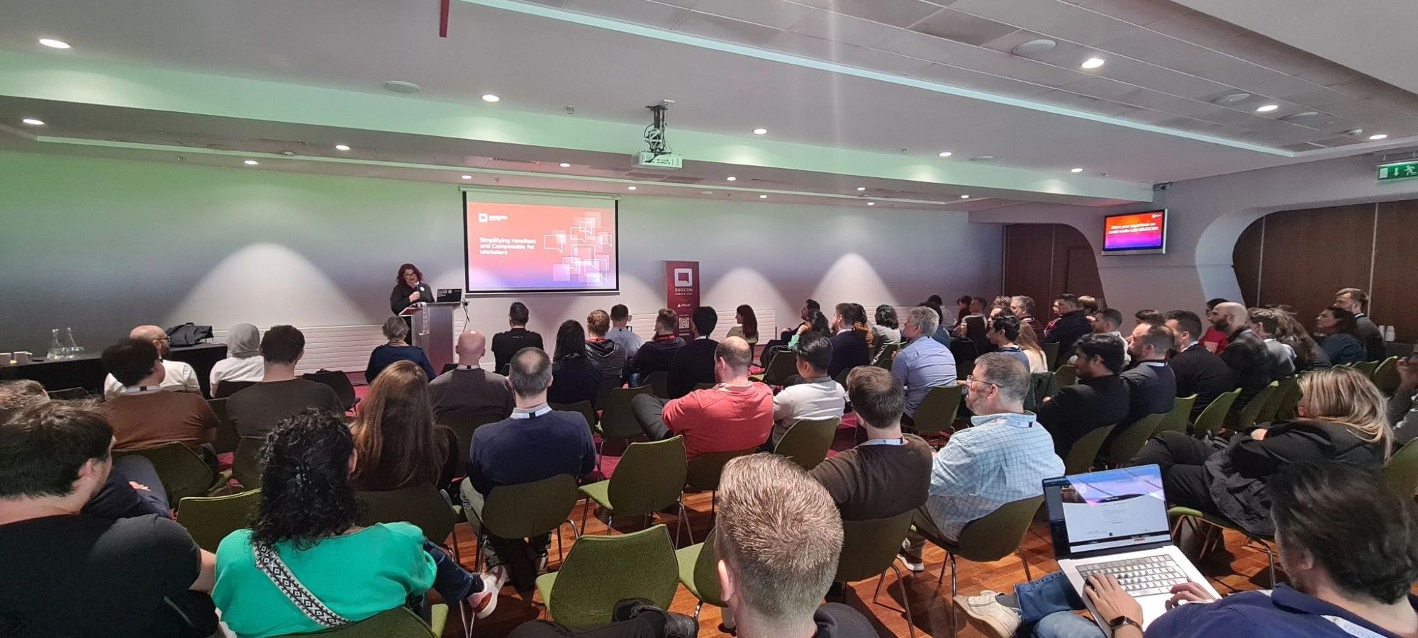 MJ stands in front of a large seated crowd at SUGCON

(Photo by Koen Heye)