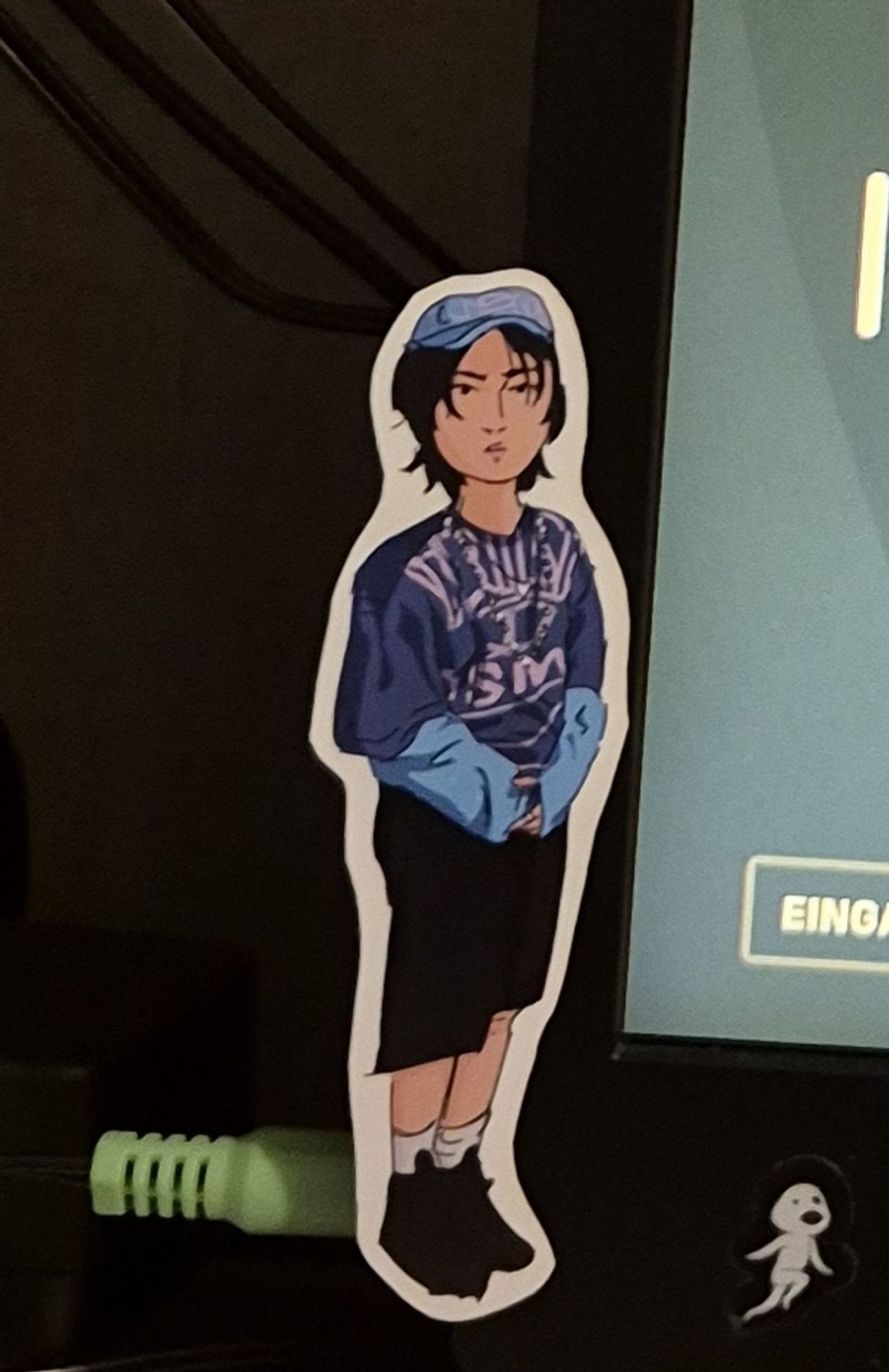 Picture of a tiny Han sticker on my screen border. 
Based on a screenshot from the Jjam MV. 
He stands there respectfully looking at the viewer, hands clasped at the front and very tiny.