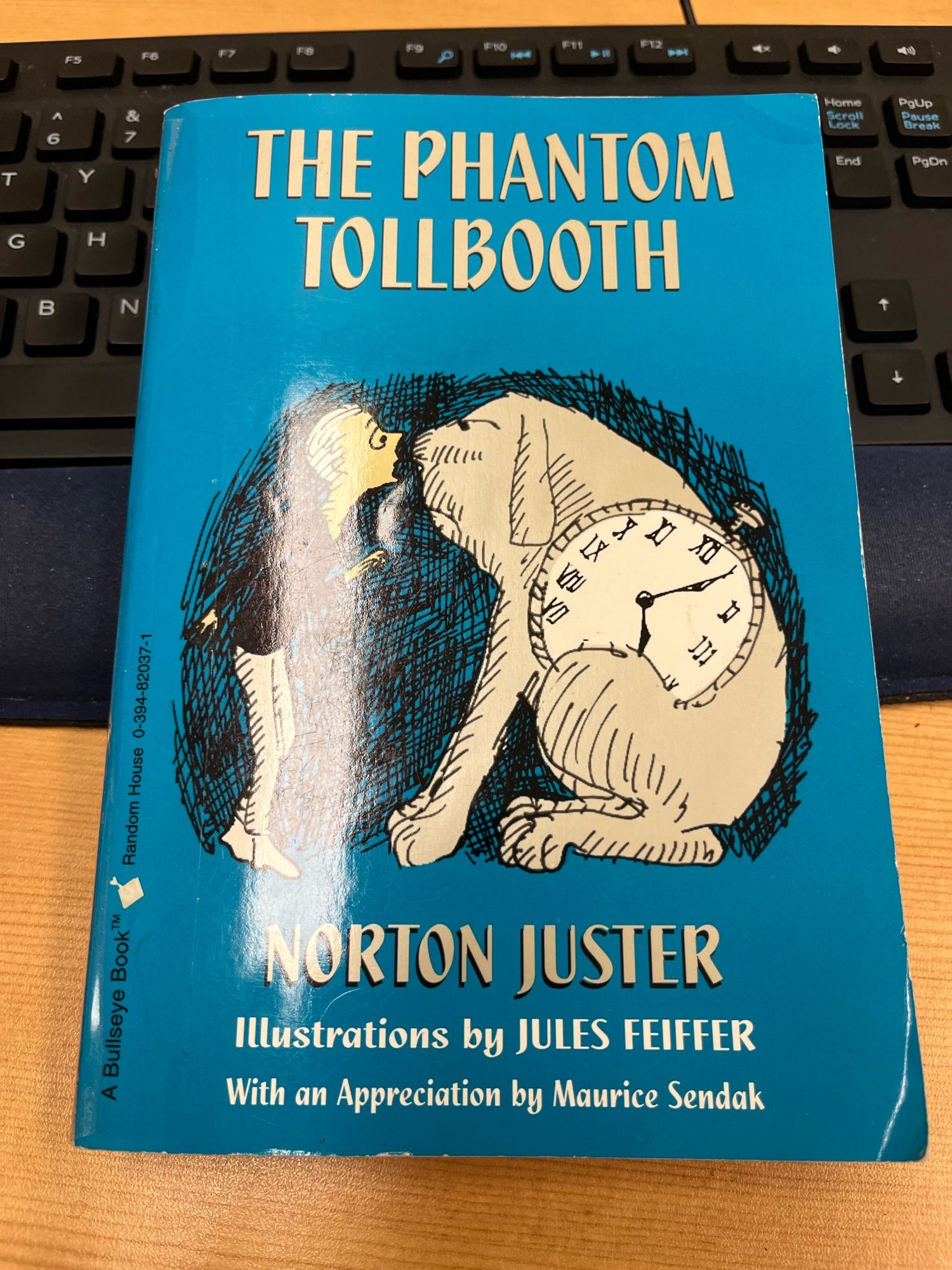 A paperback copy of The Phantom Tollbooth by Norton Juster