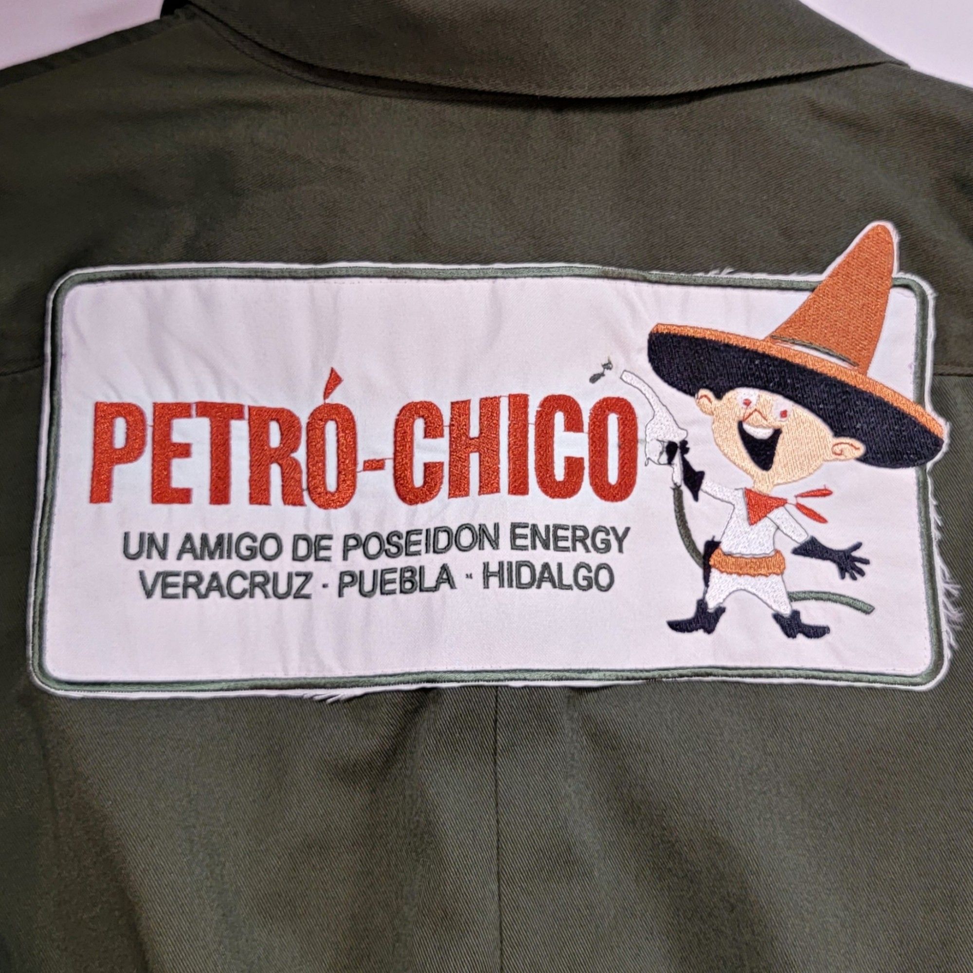 Petró-Chico from Fallout New Vegas patch sewn onto the back of a jumpsuit, featuring their mascot and text that's says: UN AMIGO DE POSEIDON ENERGY VERACRUZ PUEBLA HIDALGO