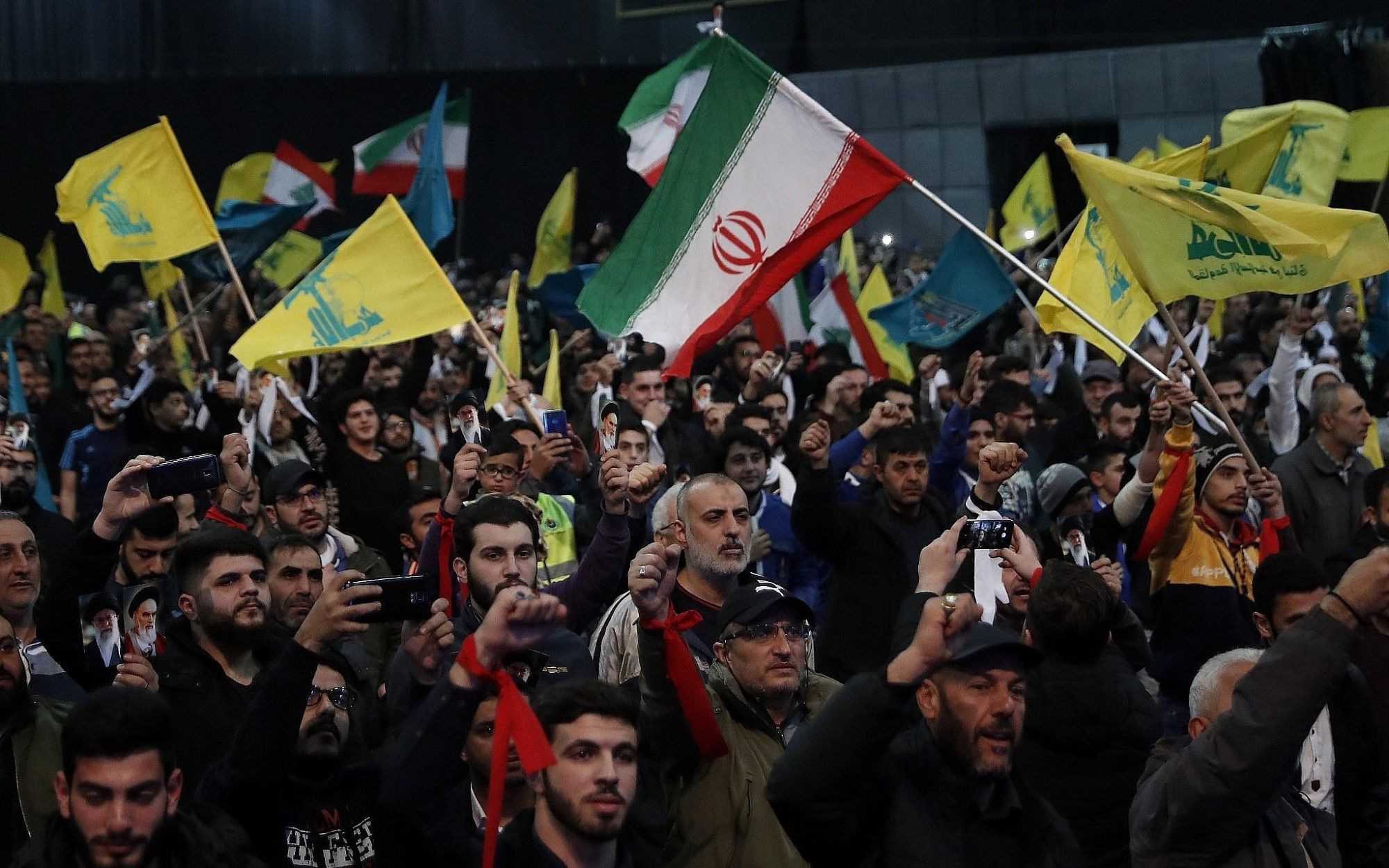 Illustrative: Hezbollah supporters shout slogans and wave Lebanese, Hezbollah and Iranian flags, during a rally to commemorate the 40th anniversary of Iran's Islamic Revolution, in southern Beirut, Lebanon, on February 6, 2019. (AP Photo/Hussein Malla)