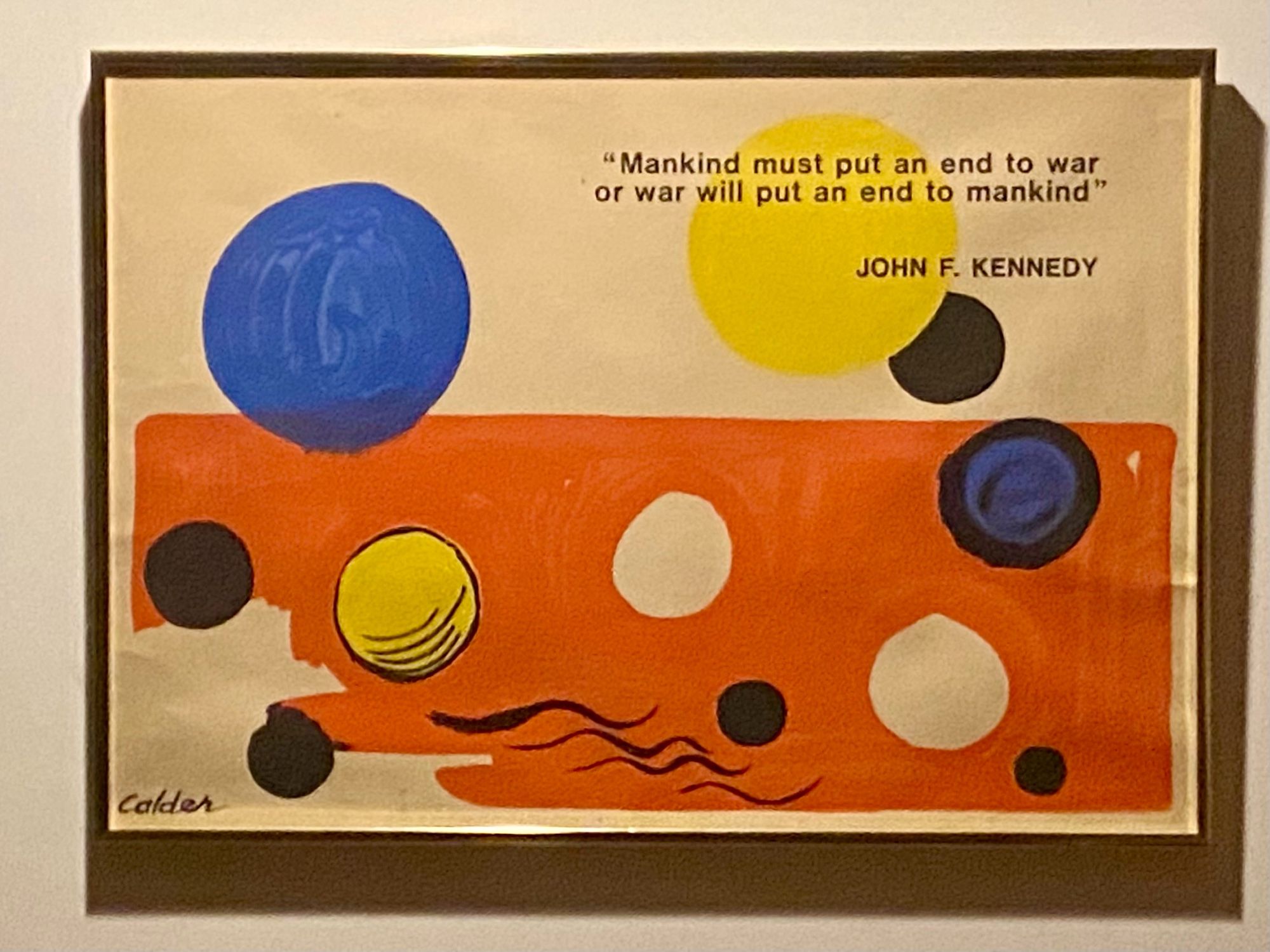 A painting of some circles and orange horizon with a quote printed on it reading "Mankind must put an end to war or war will put an end to mankind"
JOHN F. KENNEDY
Calder