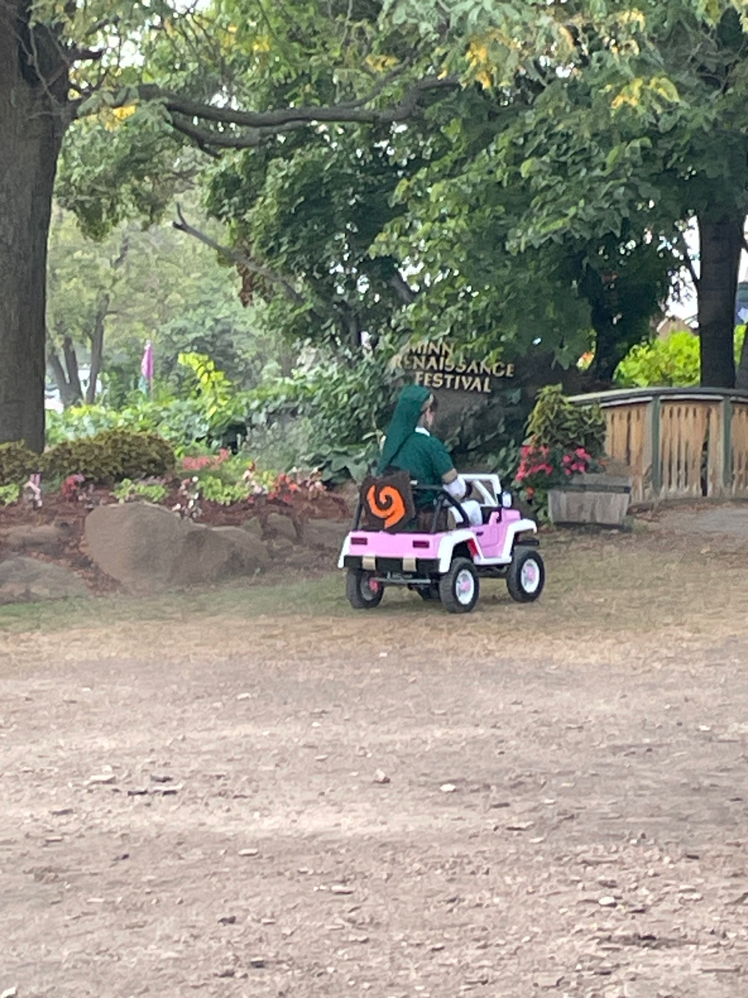 The hero of hyrule riding upon a pink jeep