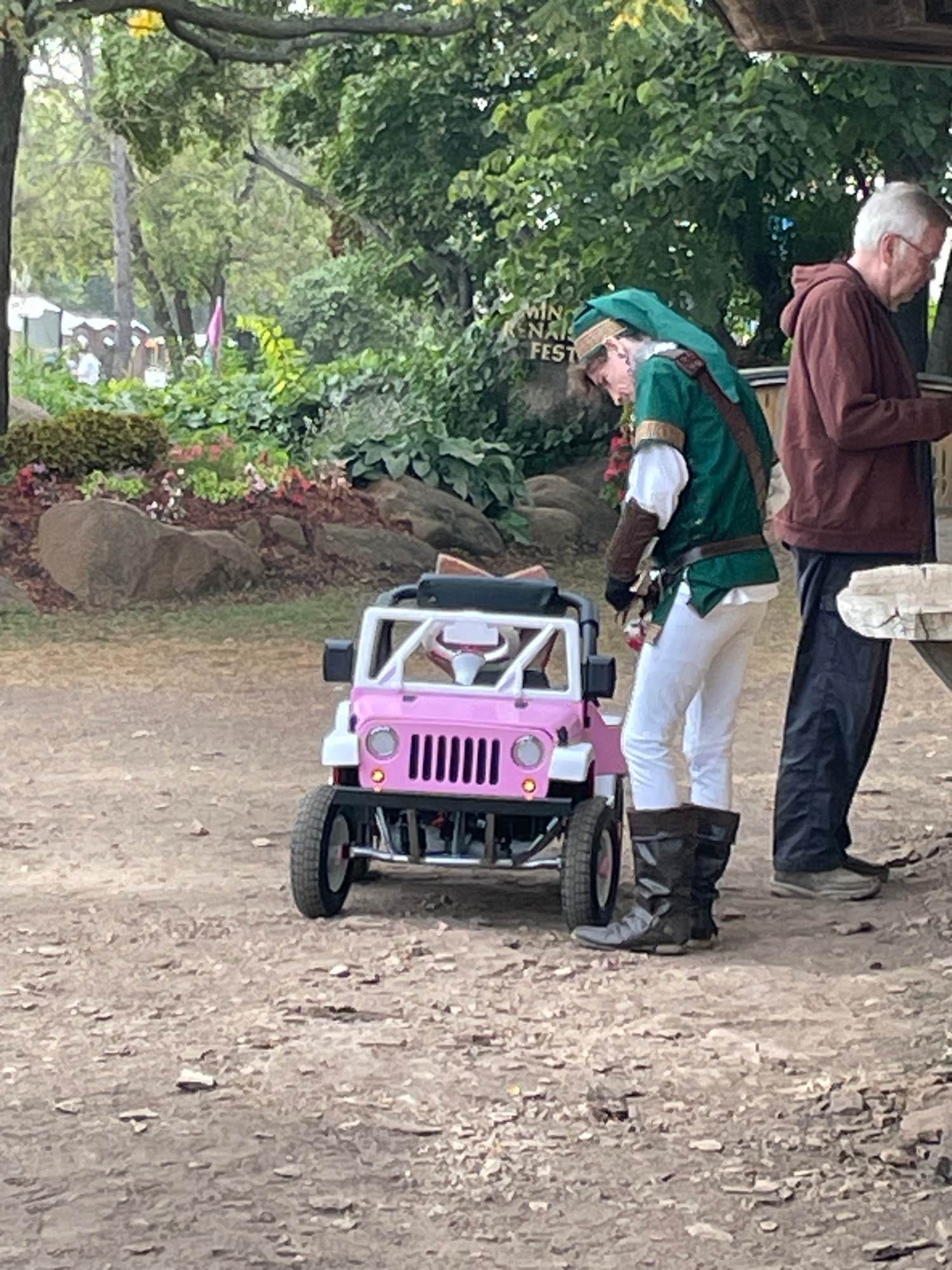 The hero of hyrule riding upon a pink jeep