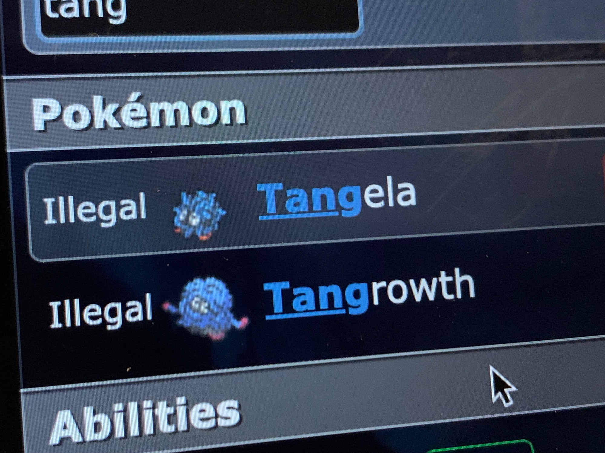 Photo of my laptop on Play.PokemonShowdown.Com Teambuilder and when you search up "tang," it returns that both Tangela and Tangrowth are ILLEGAL (although it is formatted, "Illegal"). NOW IT WILL NEVER BE THE FREAKY WEEKY!!!!!!!!!