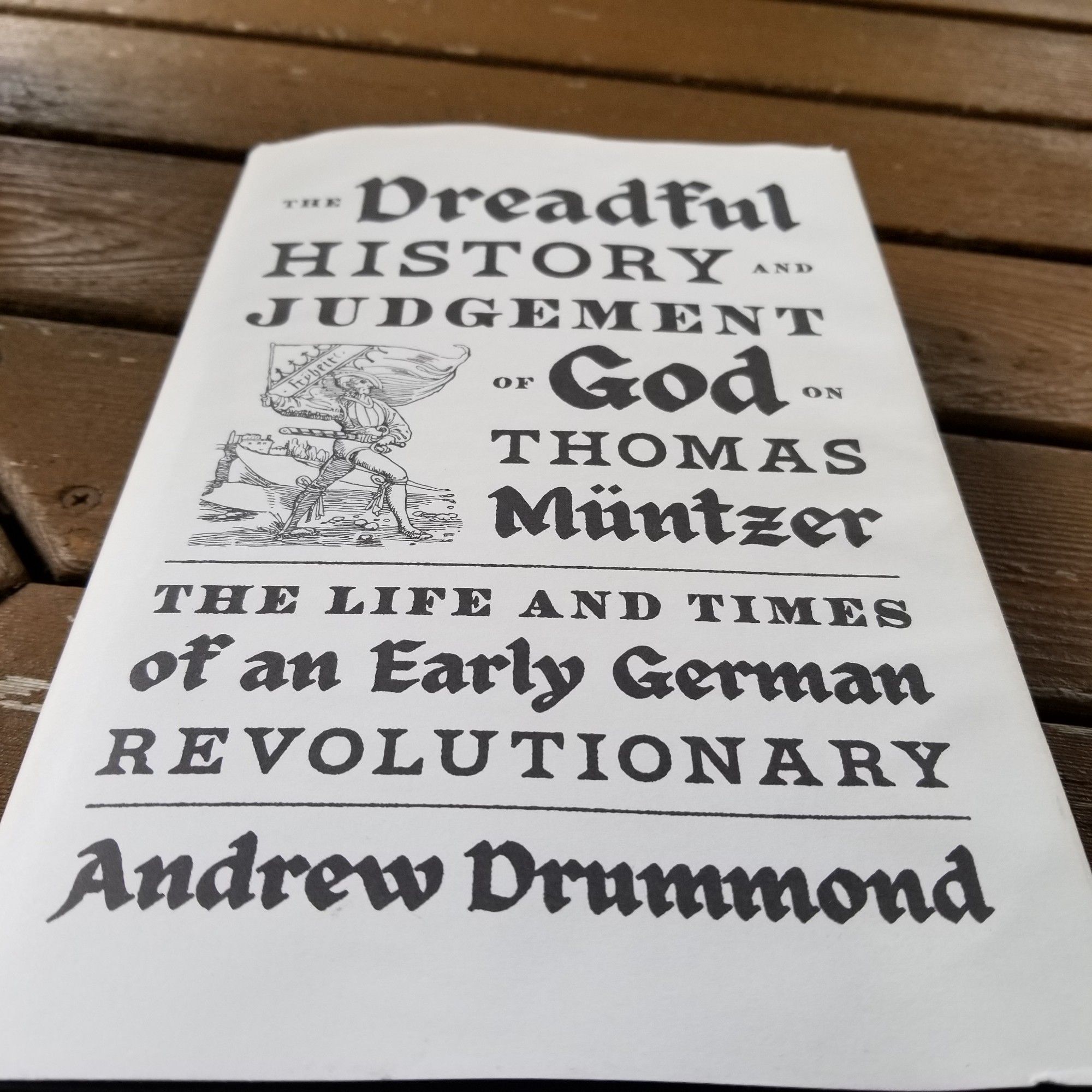 The cover of a book titled: The Dreadful History and Judgement of God on Thomas Müntzer:
The Life and Times of an Early German Revolutionary. It is in the style and font of an old Germanic woodcut.