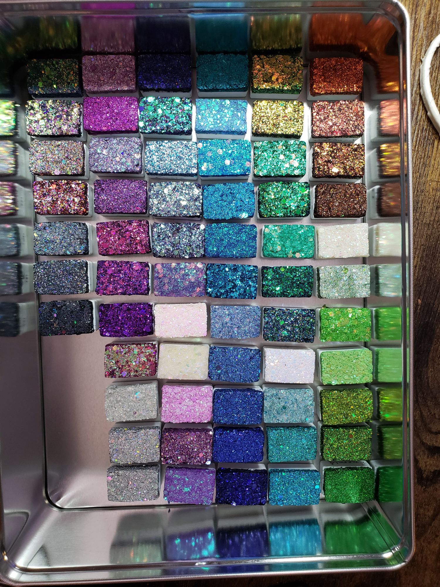 Glitter paint in big blocks of greens, blues, purples, and browns