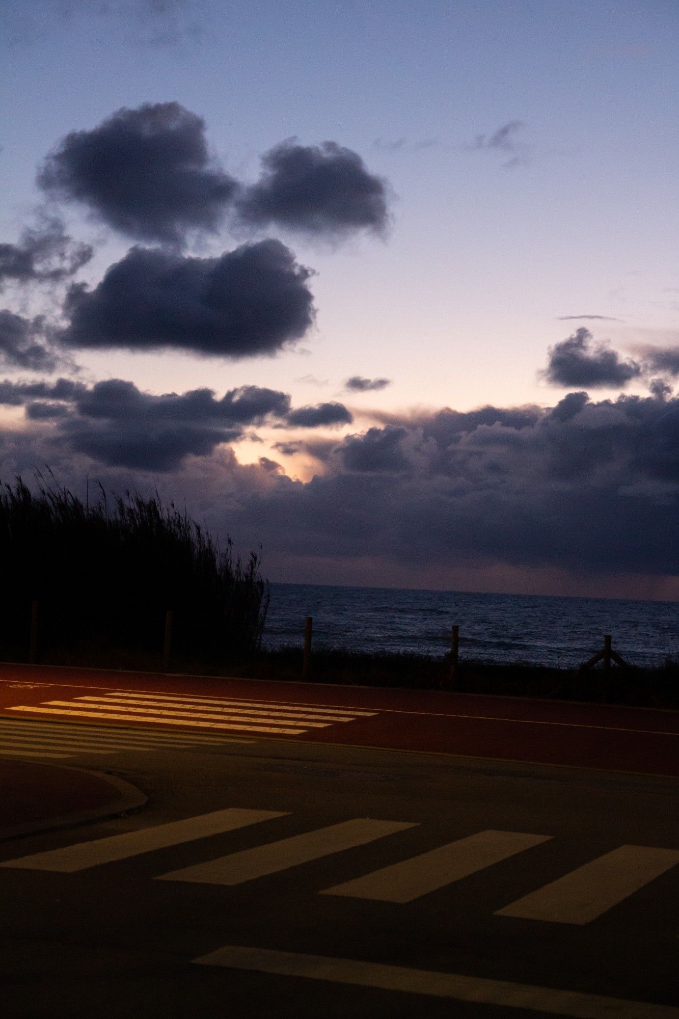 A road by the sea at sunset