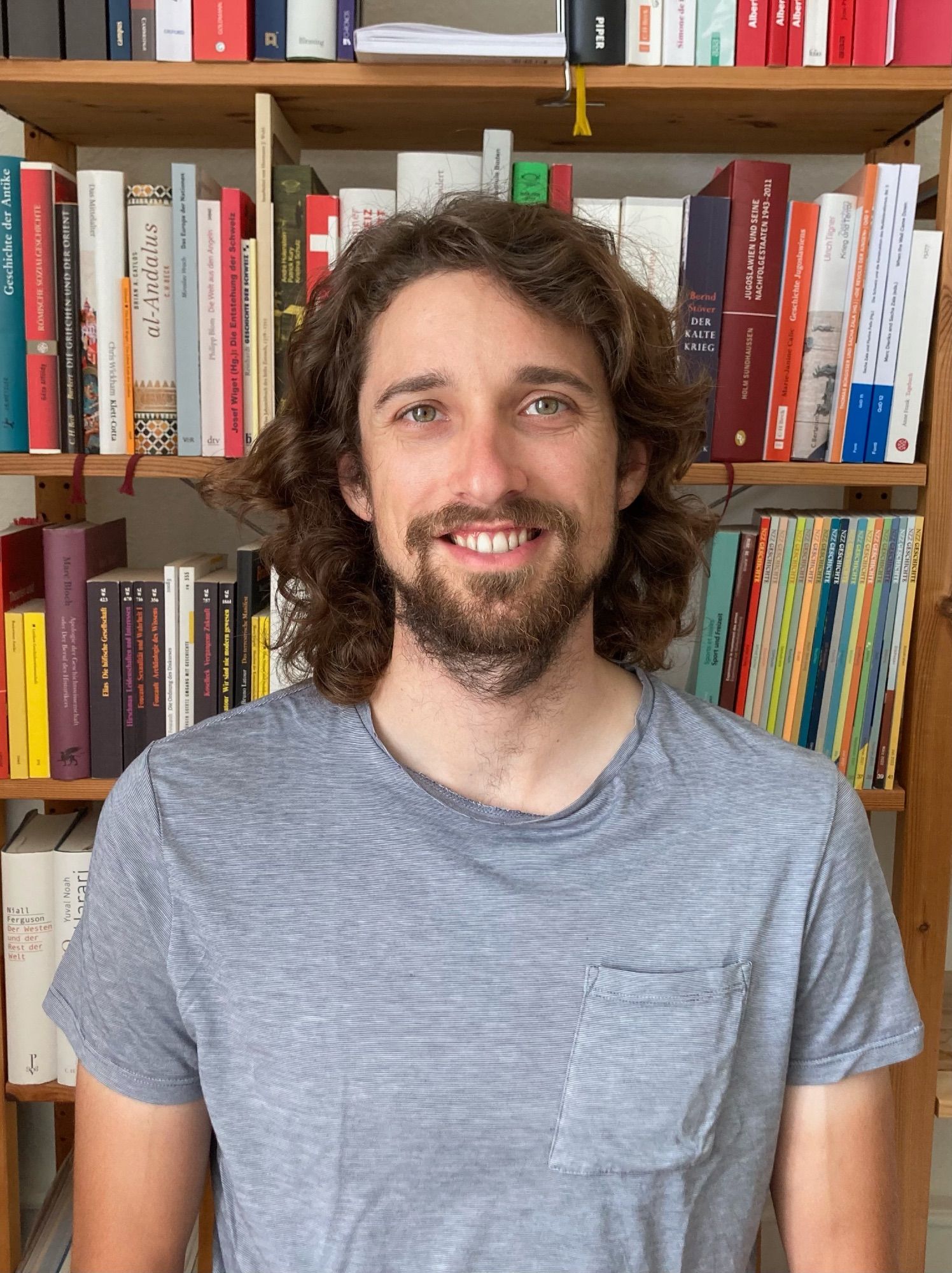 Sebastian Leitner in front of a bookshelf.