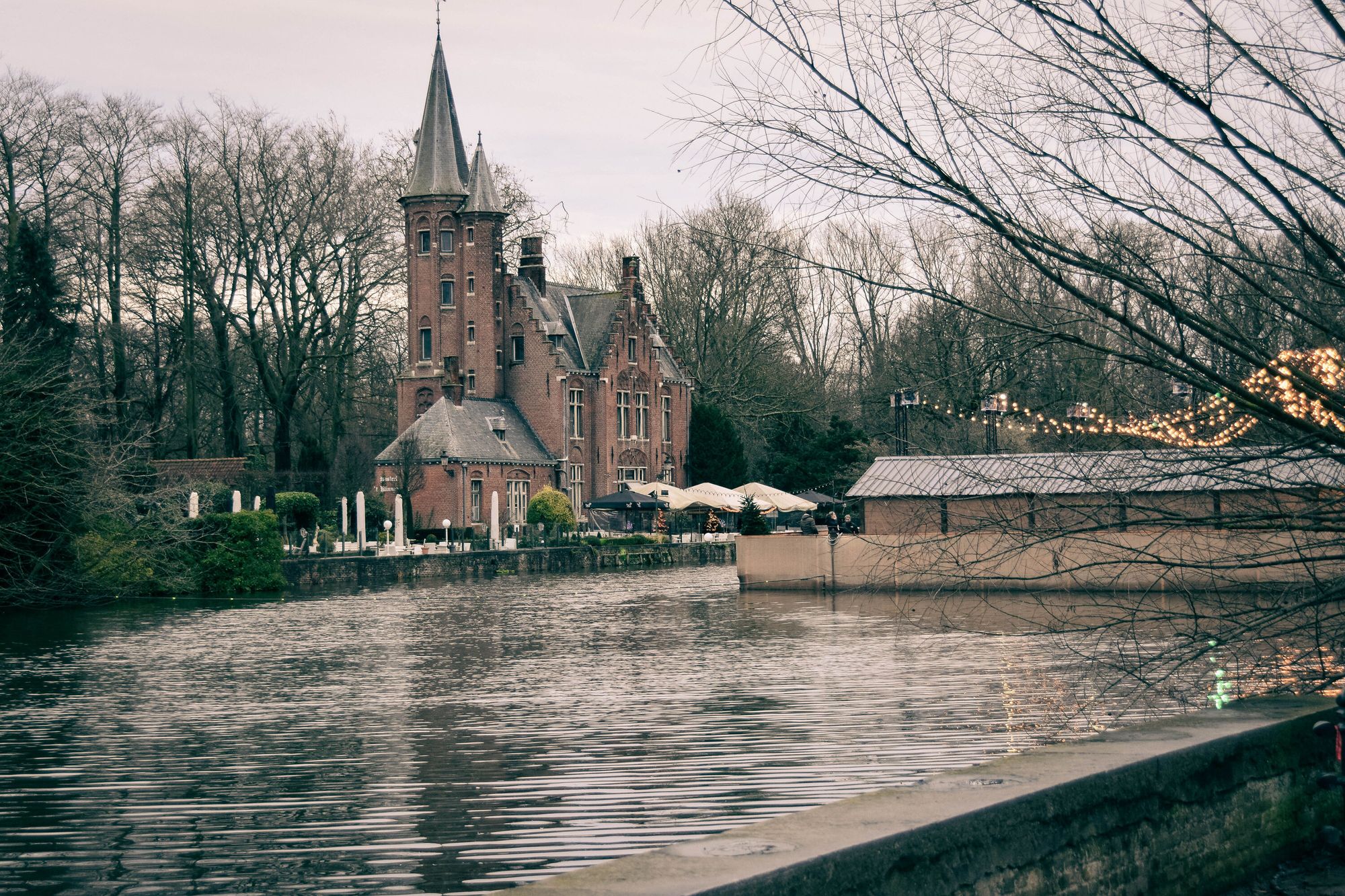 View across the water to an old building with a turret.