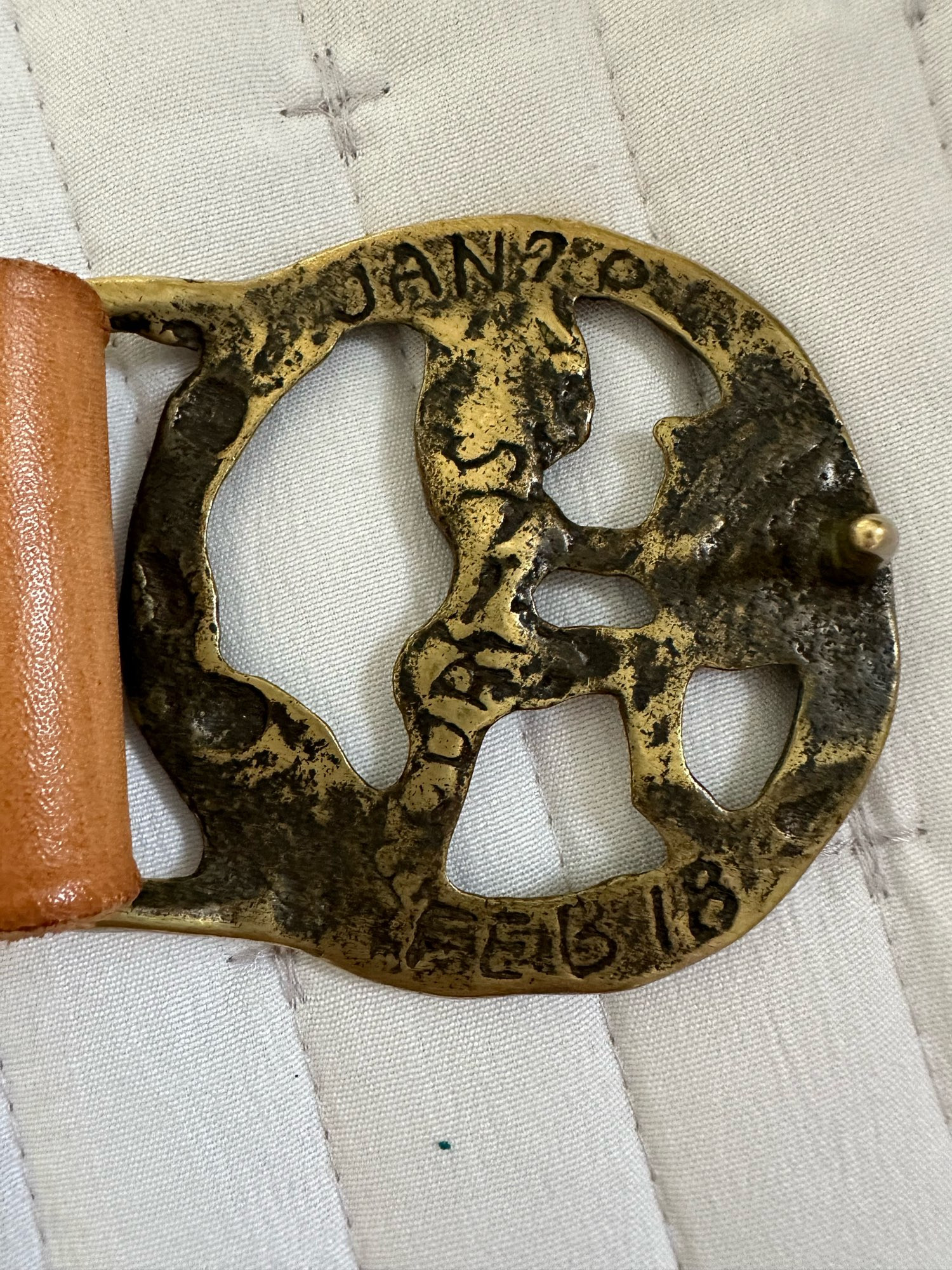 Back of the buckle with what looks like hand lettered inscriptions?