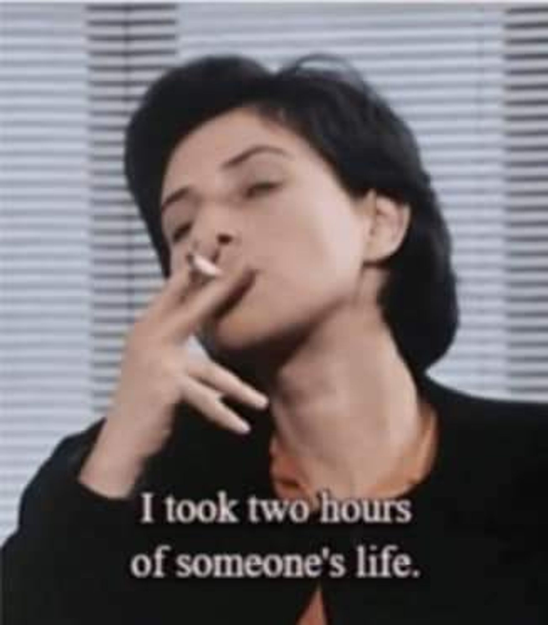 Filmmaker Chantal Akerman taking a drag from her cigarette in an interview, with caption: I took two hours of someone's life.