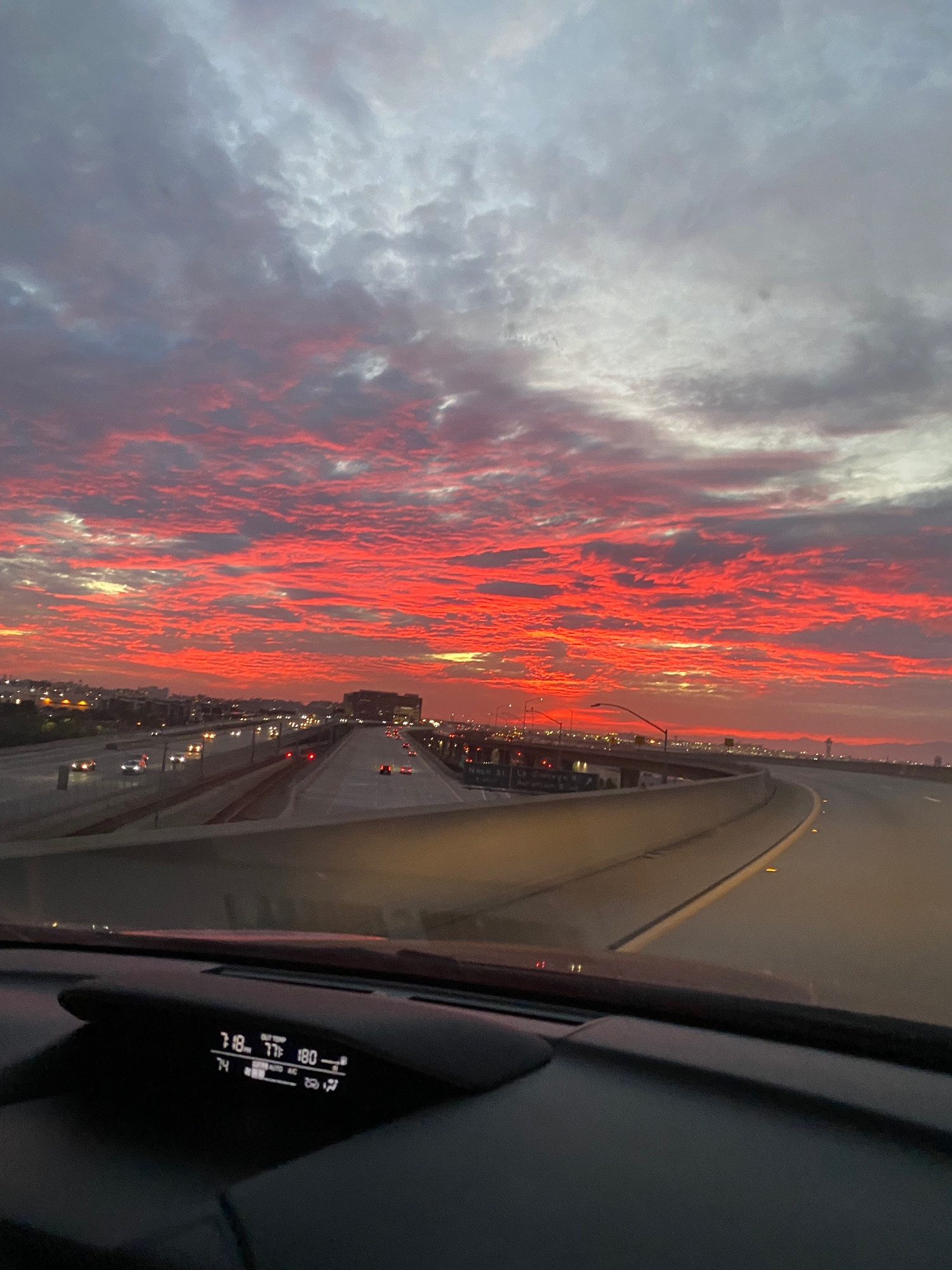 Red sun reflecting off of clouds over the highway in Los Angeles