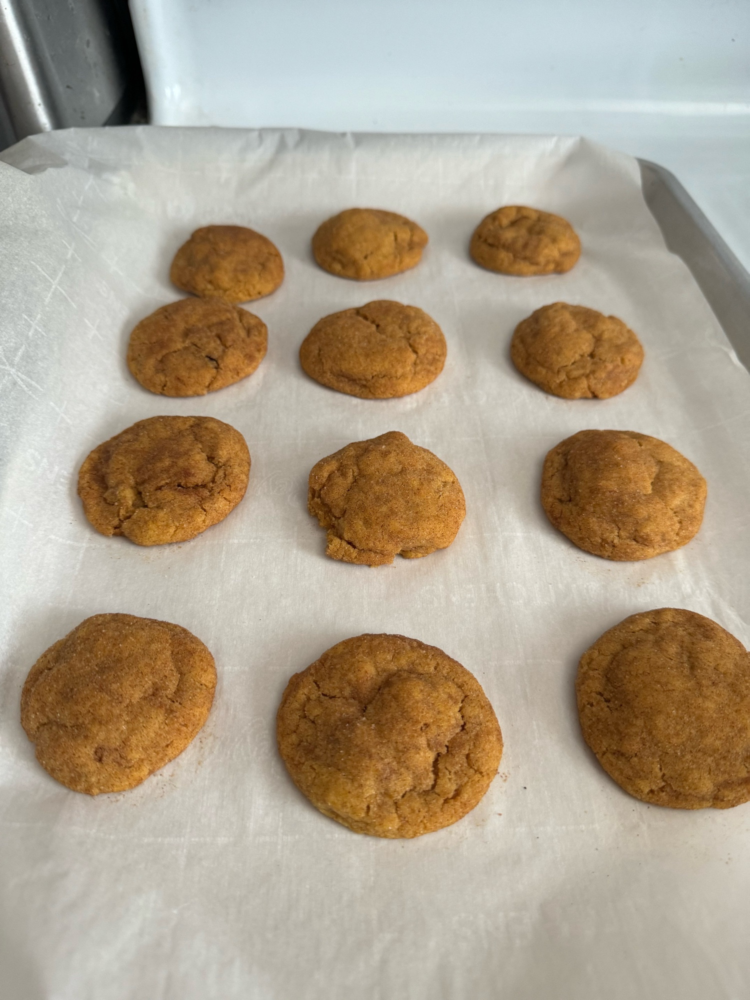 Browned butter pumpkin snickerdoodle cookies on a cookie sheet.