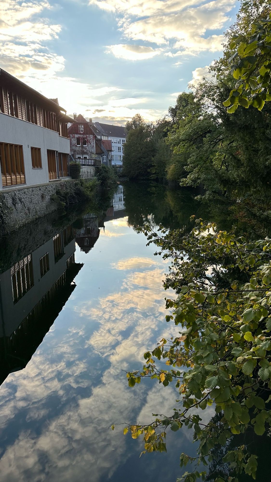 Calm water that reflects the clouds and sky