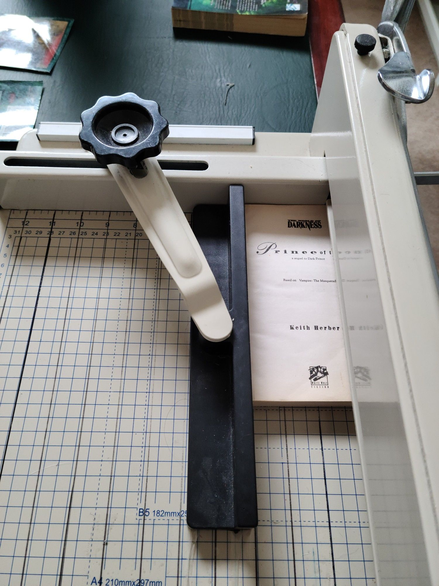 The giant industrial paper cutter I got from a local auction that we use to trim the spines cleanly off of books.