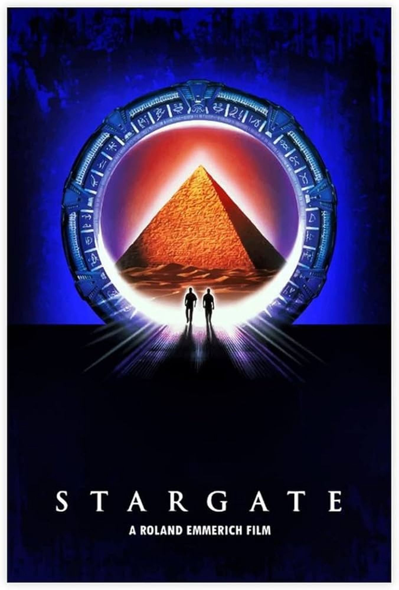 The poster's top half is deep blue. A large ornate circular portal dominates the poster. Through it is a pyramid and some desert. 2 tiny silhouettes are walking through the portal. The bottom half of the poster is black. At the bottom is white font that says "Stargate" and below that "A Roland Emmerich film".