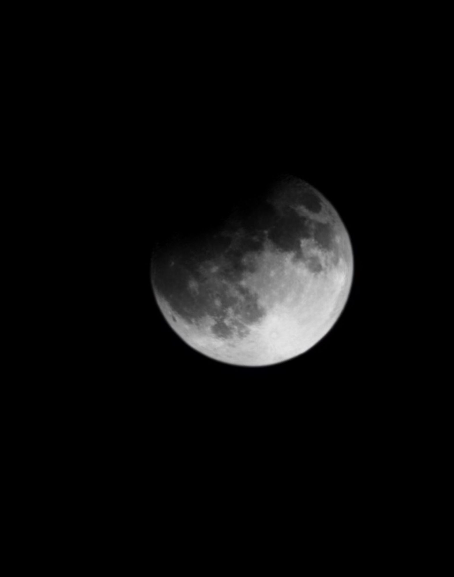 Picture of full moon with top left side darkened by partial lunar eclipse