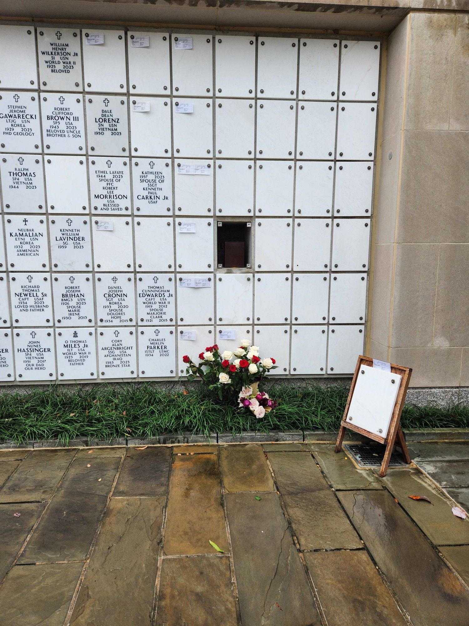 Flowers rest on the ground near the open columbarium that now holds World War II veteran Dot Swain Lewis.