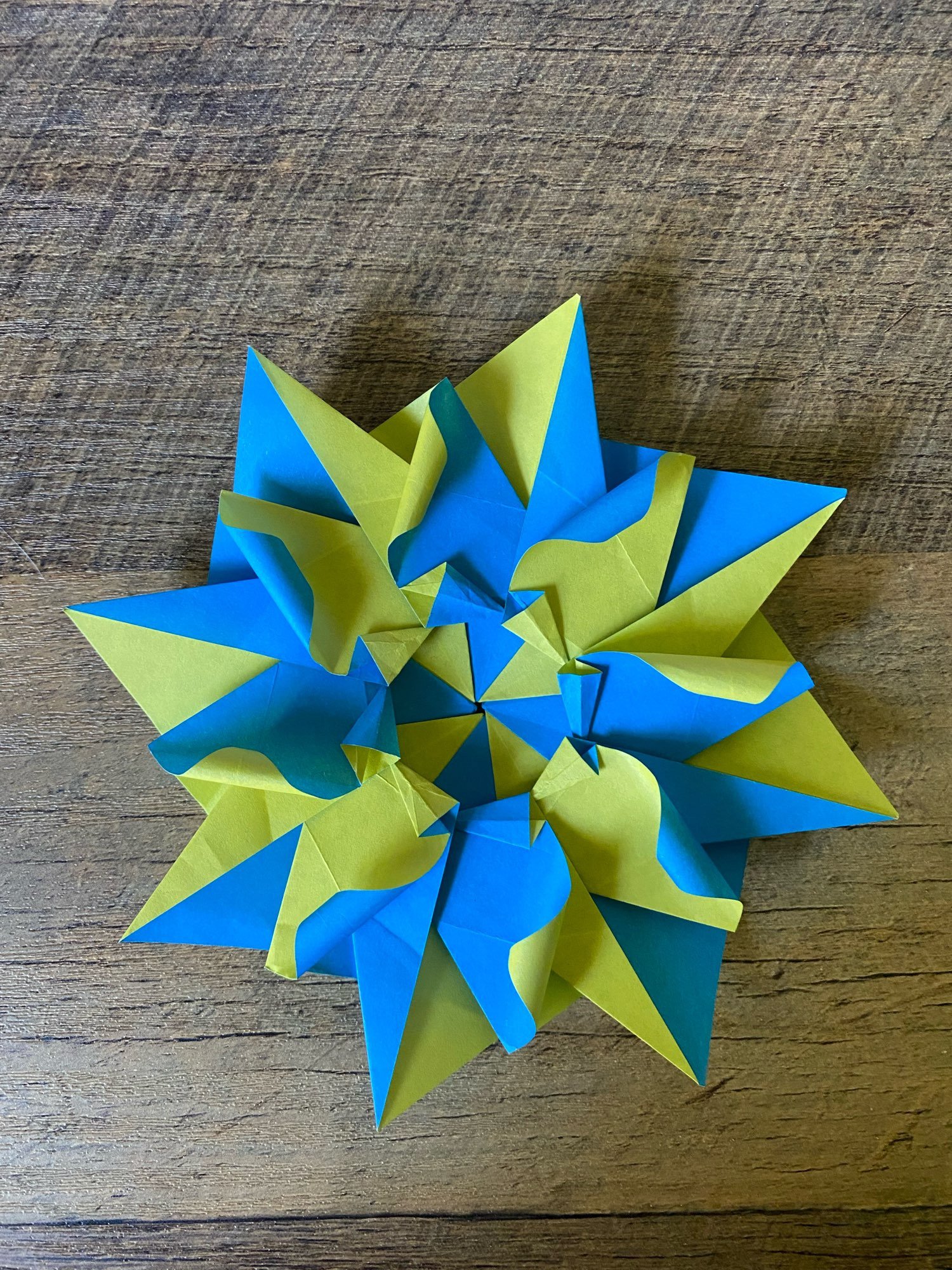 Eight-piece modular “mandala” alternating blue and yellow paper.