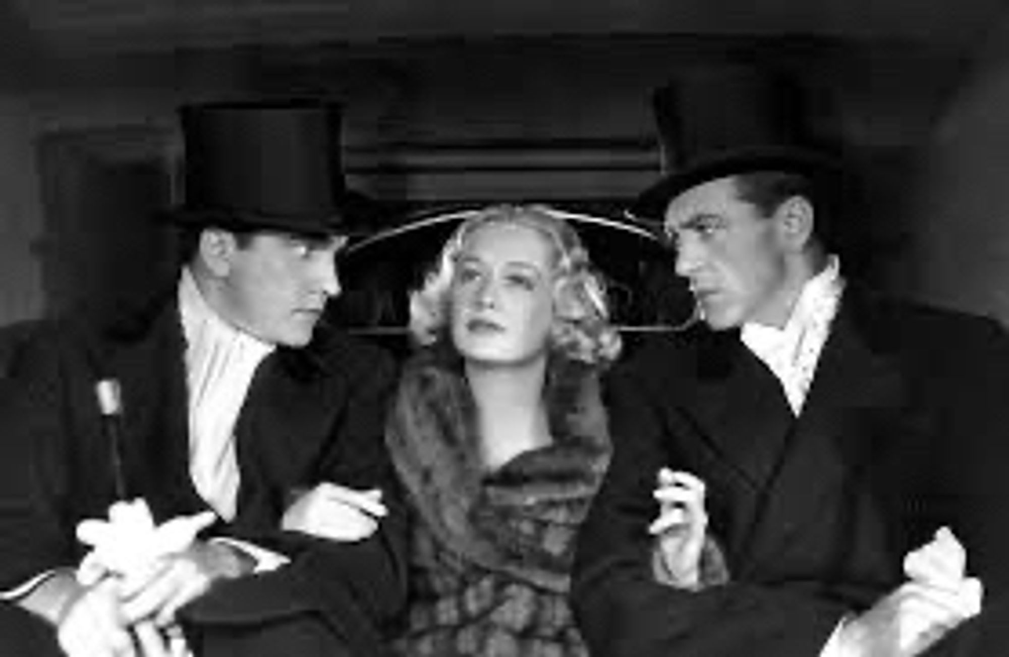 All three characters in the back of a taxi with Miriam Hopkins holding both men’s arms