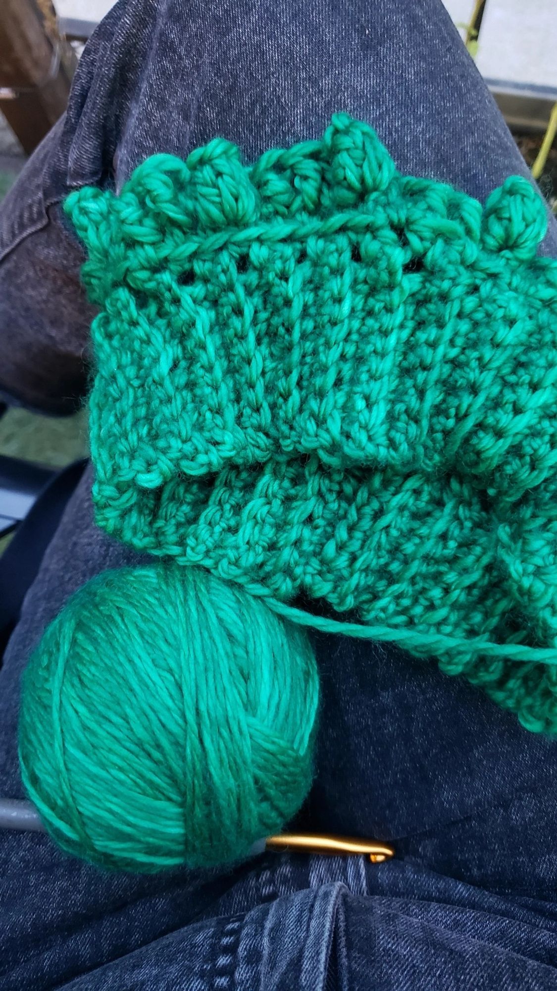 A ball of green yarn and current crochet project I'm working on