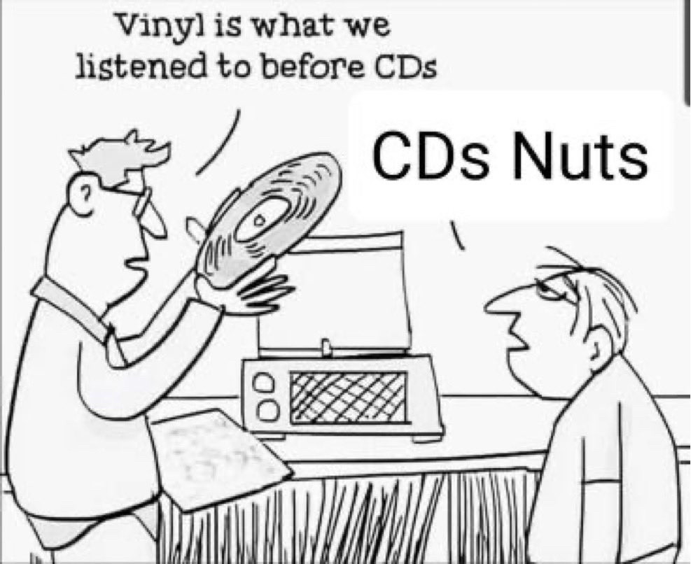 newspaper style comic. a father puts a record on a player while his son watches.
F: vinyl is what we listened to before CDs
S: CDs Nuts