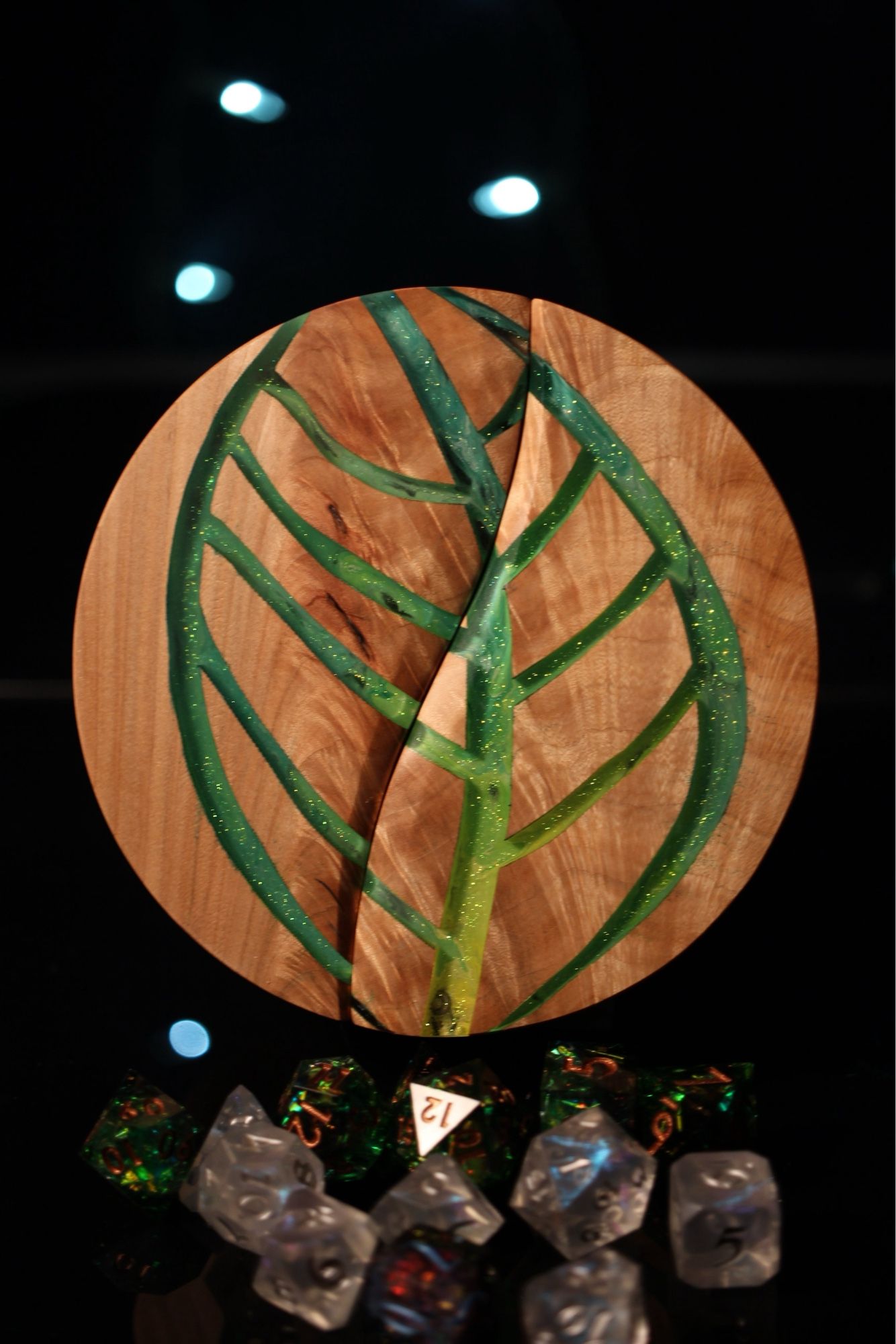 Round maple dice box with a leaf shape cut out filled with yellow and green epoxy incorporated into the top.