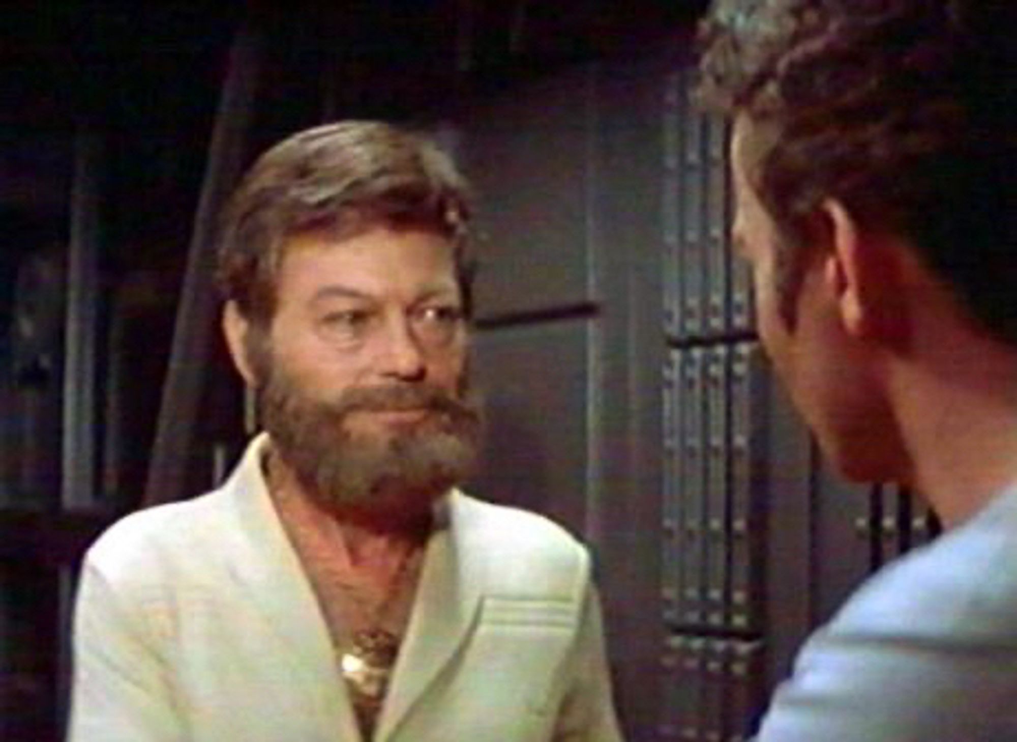 Picture of Bones from Star Trek The Motion Picture looking absolutely bullets. His beard is the thing of legend. His gold medallion is spot on. Flowing chest hair and a white jumpsuit. My god it’s beautiful.