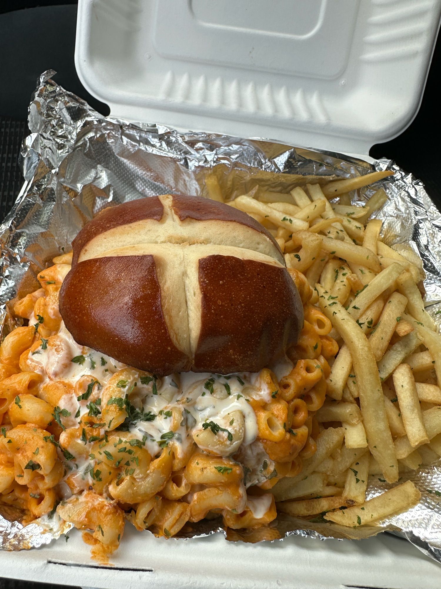 Burger on pretzel bun with altogether too damn much mac and cheese