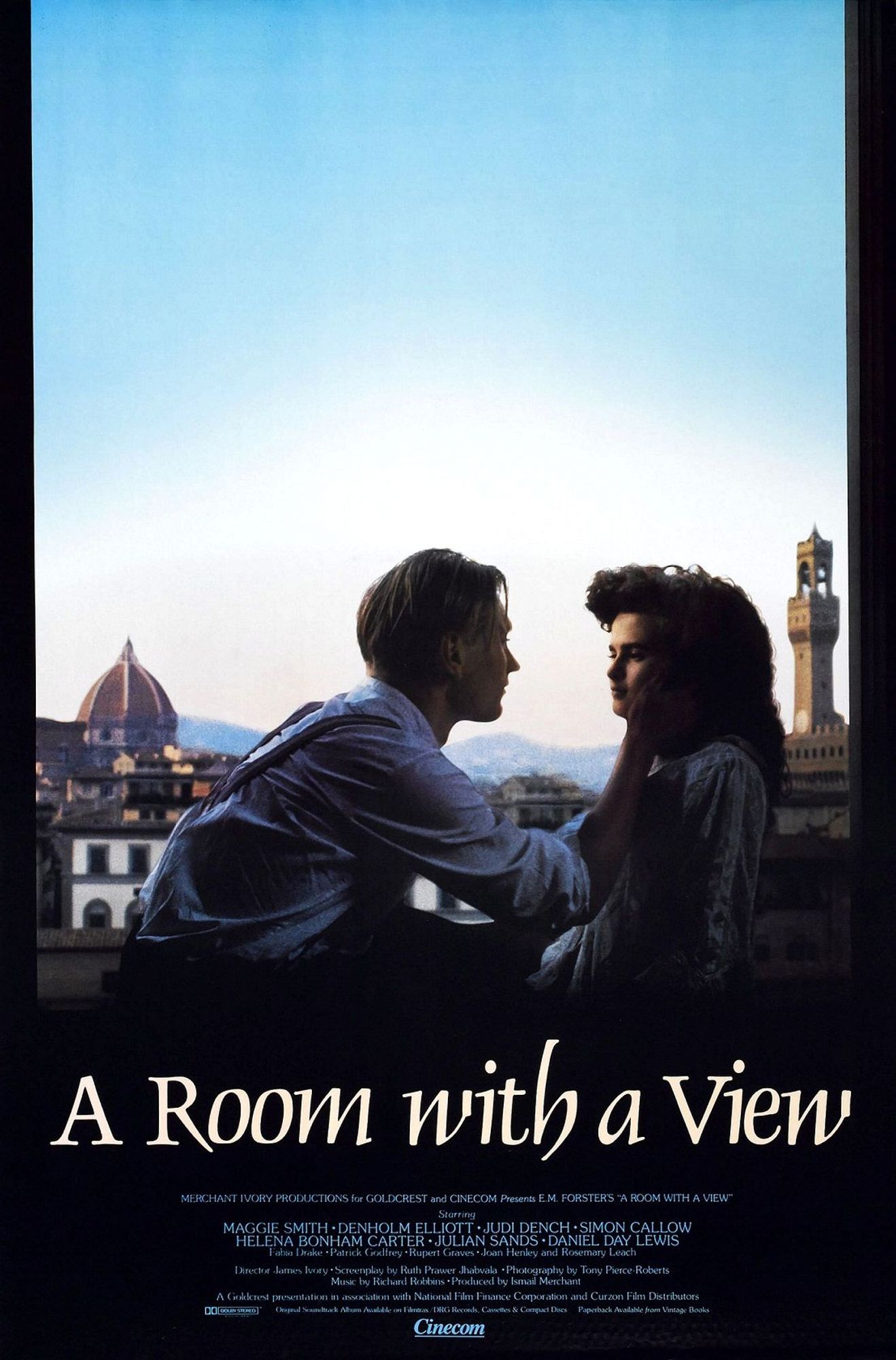 The poster for A Room With A View has a young Julian Sands holding Helena Bonham Carter's face. The background is a blue sky and the buildings of Florence.