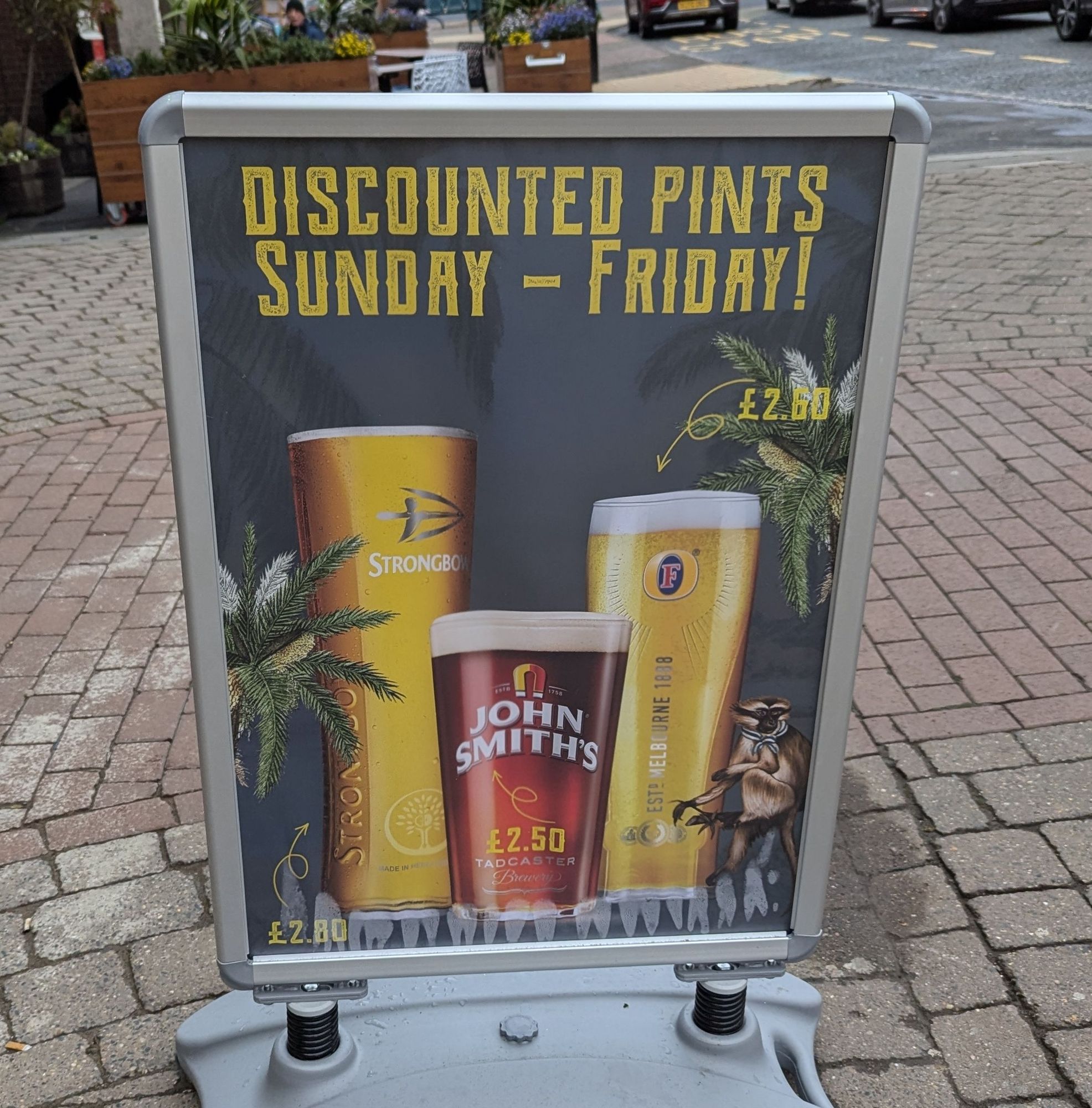 A pub sign advertising discounted drinks between Sunday and Fridays